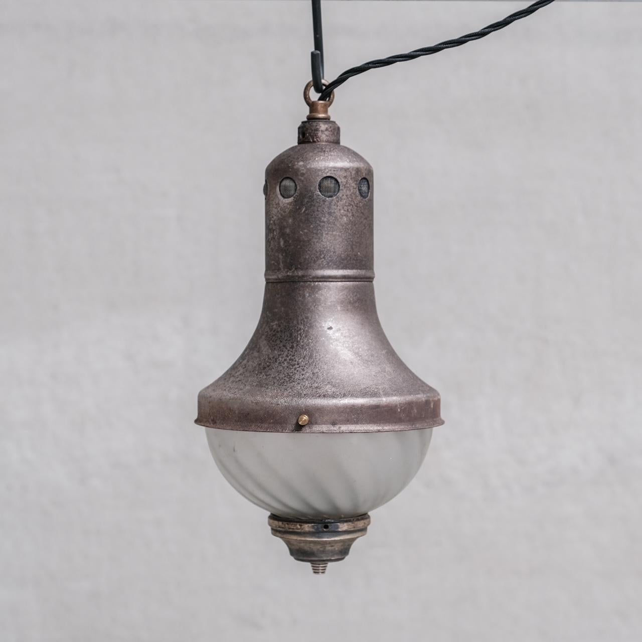 A set of three exceptional pendant lights. 

Patinated metal and opaque swirl glass. 

France, c1920s. 

PRICE IS FOR THE SET OF THREE. 

Since re-wired and PAT tested. 

No Additional Chain or Rose was retained so will not be provided. They can be
