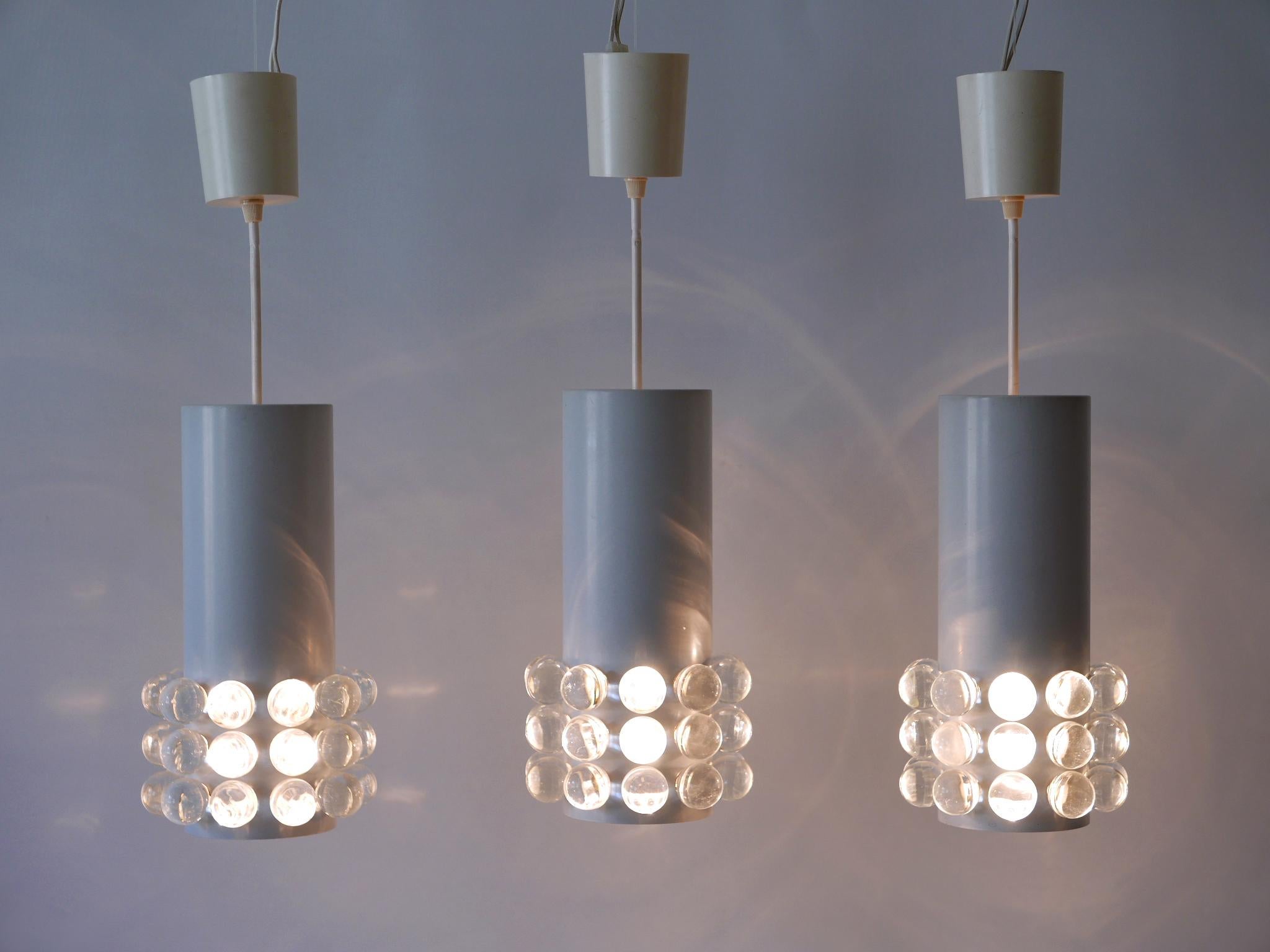 Set of three rare, lovely and highly decorative Mid-Century Modern pendant lamps or hanging lights with large glass cabochons. Designed and manufactured in Germany, 1960s.

Executed in metal and glass, each pendant lamp comes with 1 x E27 / E26