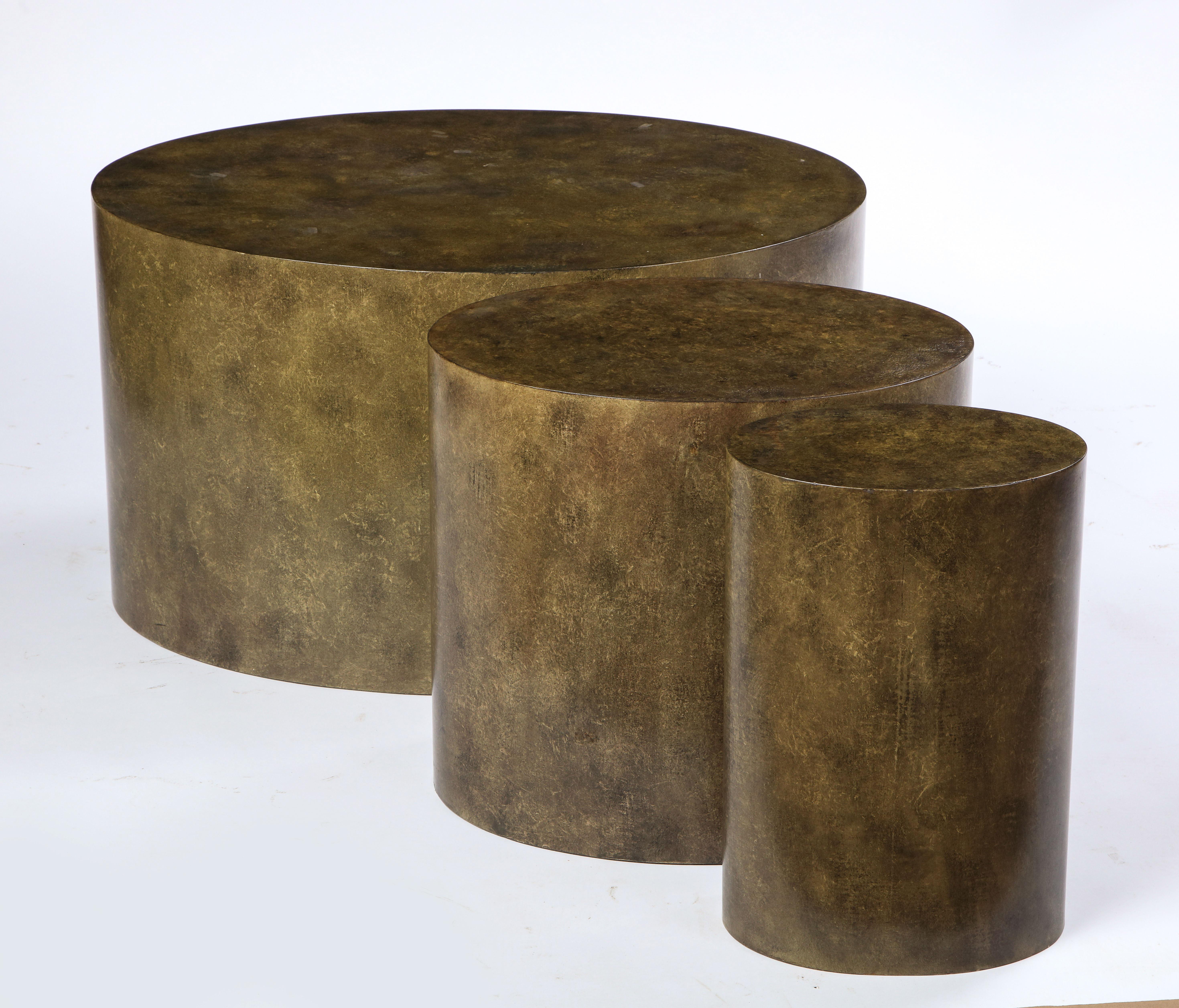 Set of three graduated low tables composed of a wooden frame covered in canvas painted in a faux metal finish. Juan Montoya intended these tables to be prototypes, but they never went into production. Modern in style, these oval tables are in sizes