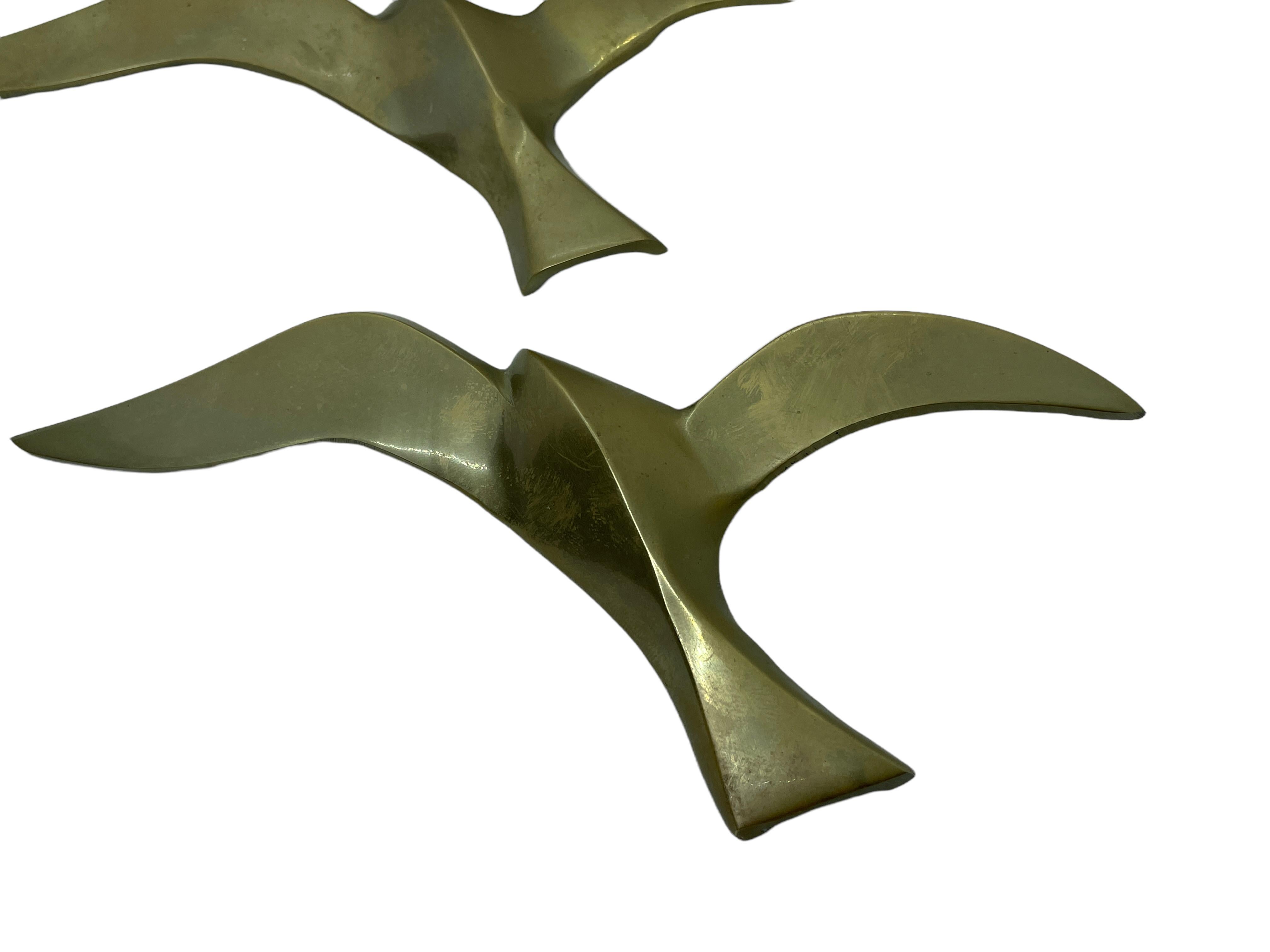 A set of three beautiful vintage brass flying swallow wall decorations. Each would make a beautiful ornament on a wall. They are with some patina and are an excellent craftsmanship. Made in the 1960s it displays the joy of that great era with a