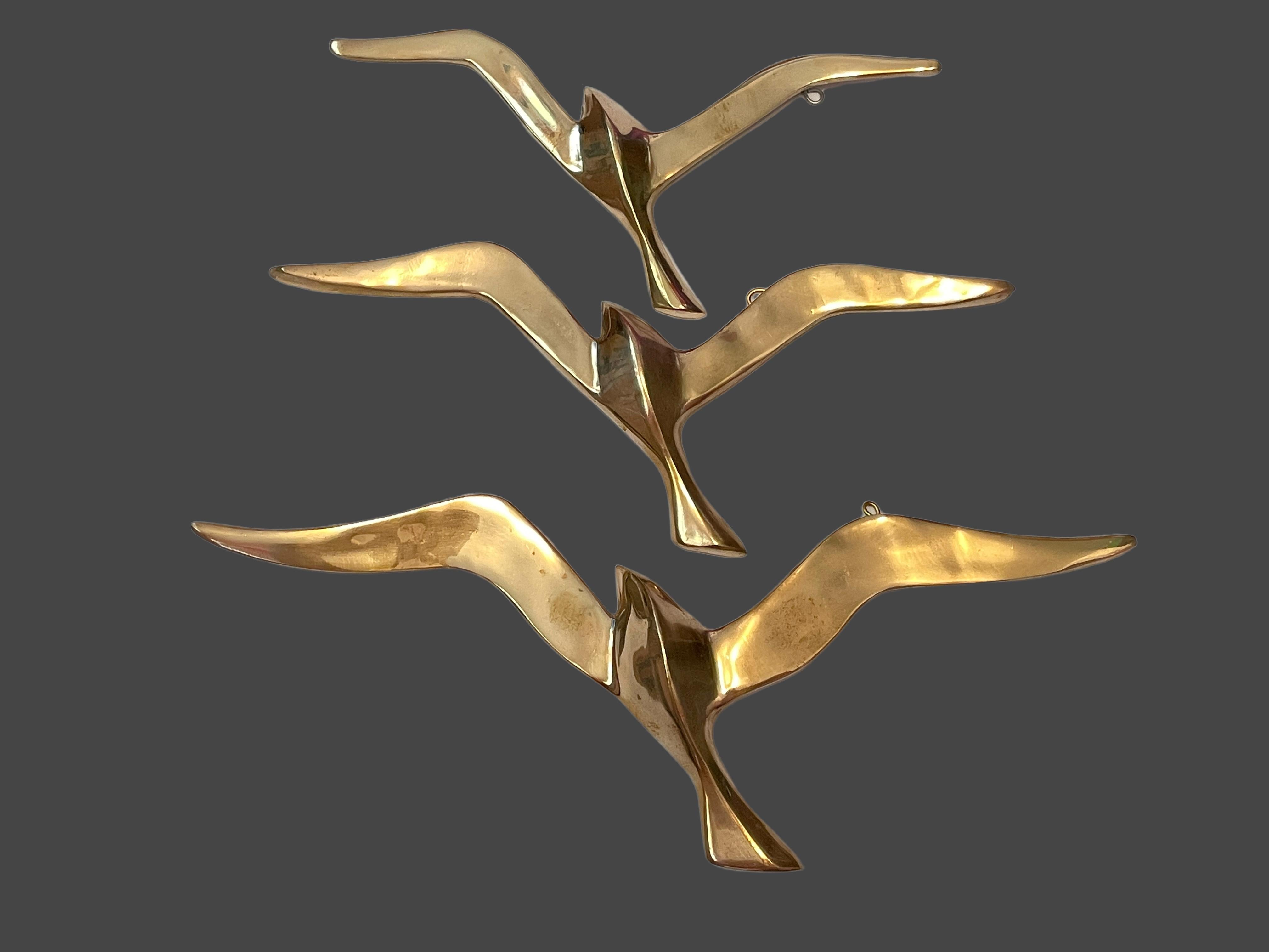 A set of three beautiful vintage brass flying swallow wall decorations. Each would make a beautiful ornament on a wall. They are with some patina and are an excellent craftsmanship. Made in the 1960s it displays the joy of that great era with a