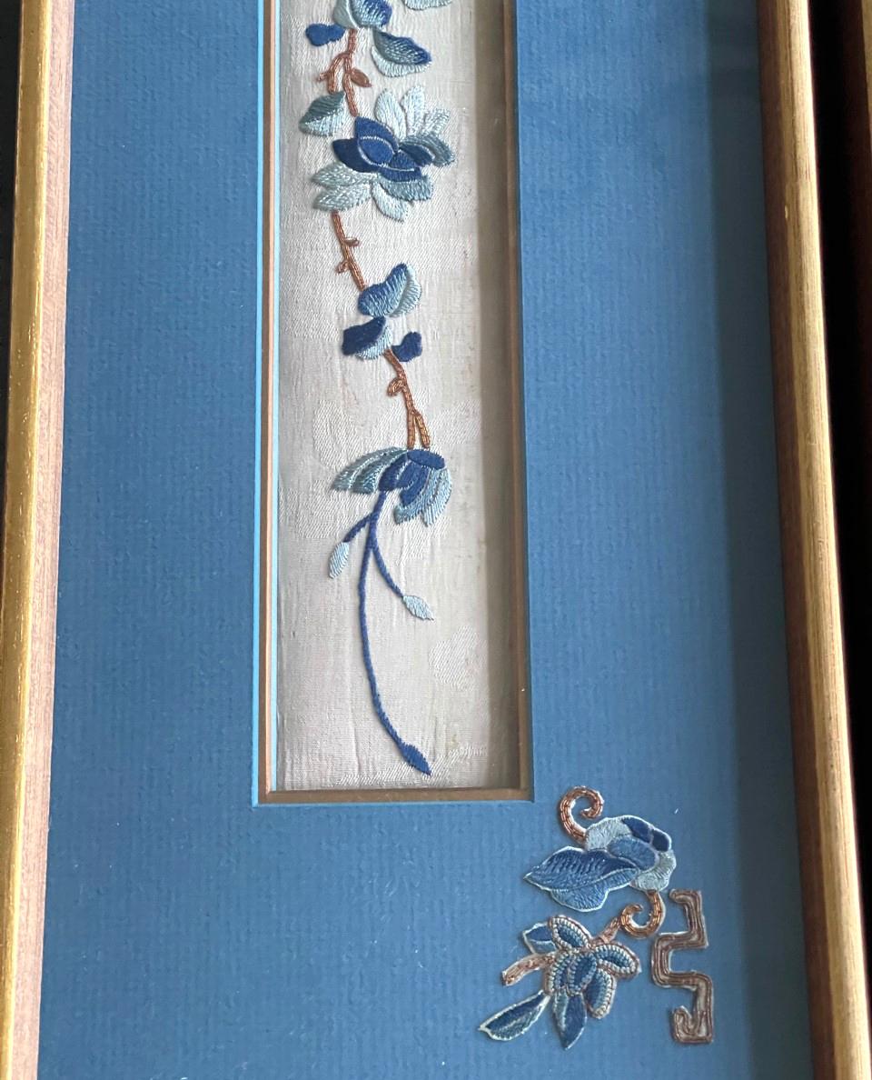 A set of three antique textile fragments from China, circa 19th century Qing dynasty, professionally displayed in matching giltwood frames as a triptych. Originally they were embroidered panels from semi-formal skirt worn by Manchurian ladies. Satin