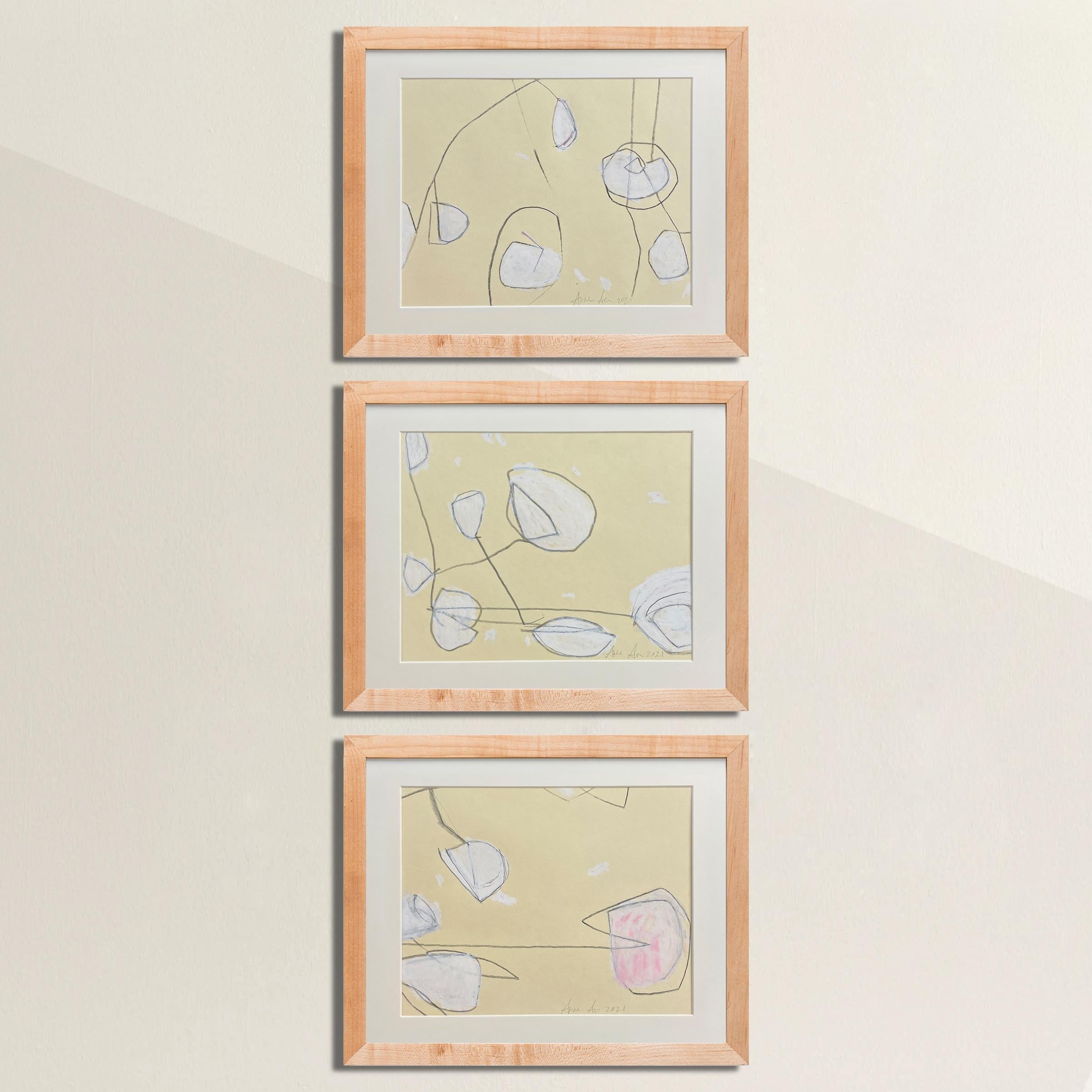 A beautiful set of three framed abstract drawings by artist, Anne Abueva, rendered in conté crayon on paper and framed in simple maple gallery frames.

Interior designer Anne Abueva made the decision ten years ago to put down the paint fan deck