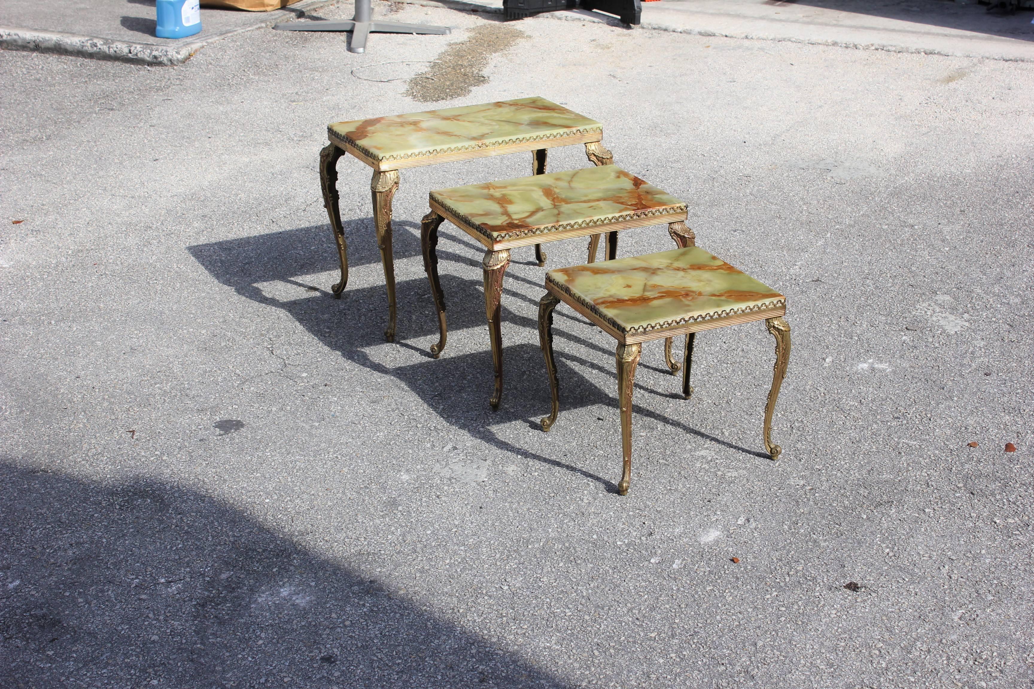Set of three French Maison Jansen bronze onyx top nesting tables, circa 1940s, the onyx are in beautiful color green and perfect condition, the table are in bronze and perfect condition.