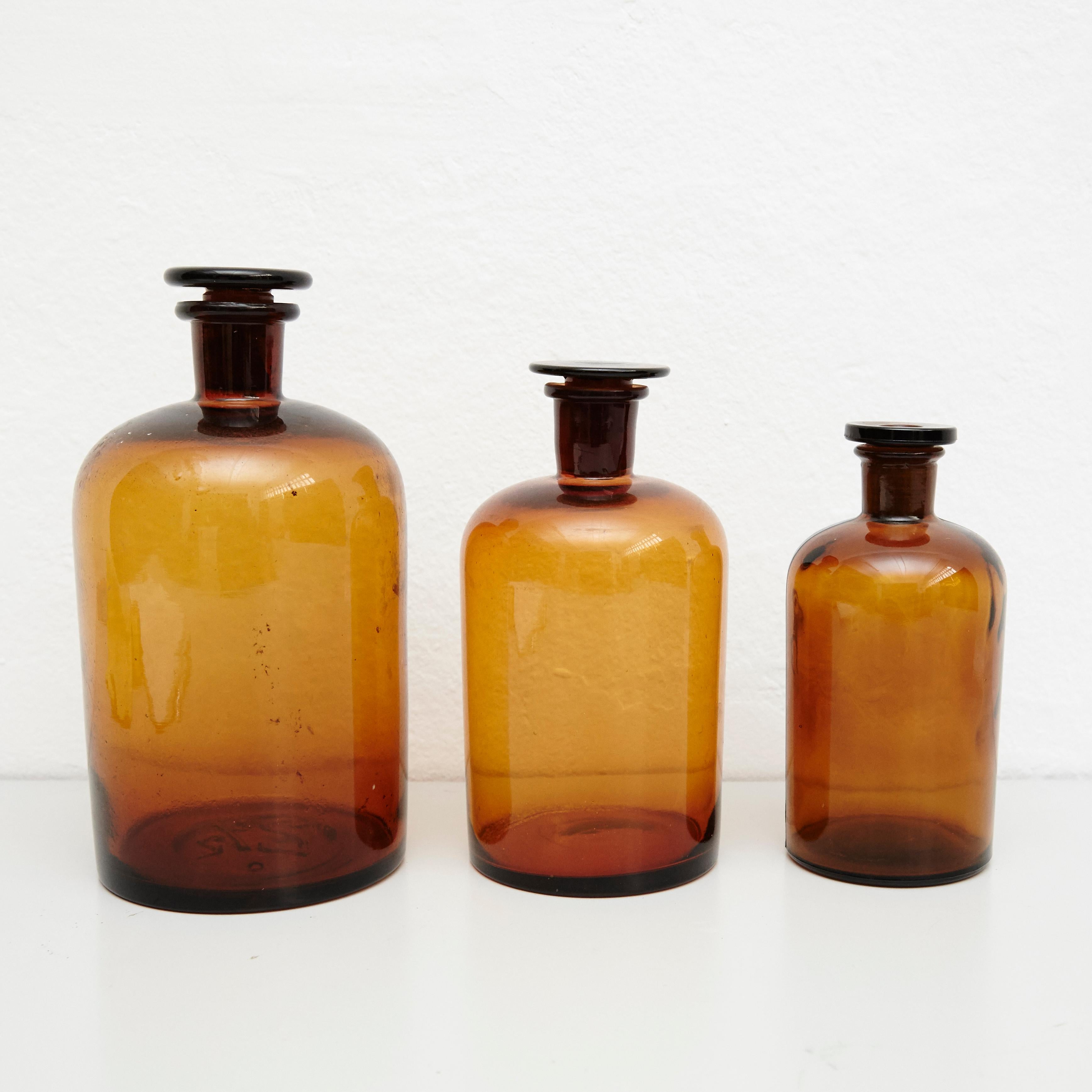 Set of three French vintage amber glass pharmacy bottle.
By unknown manufacturer, France, circa 1930.

In original condition, with minor wear consistent with age and use, preserving a beautiful patina.

Materials:
Amber