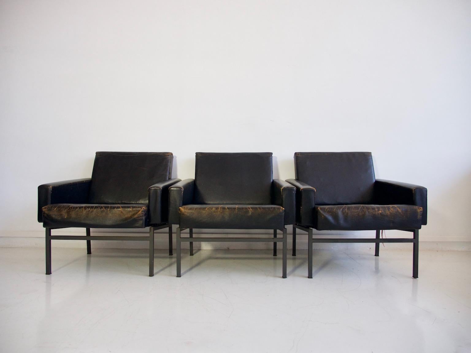 Three armchairs by Friedrich Wilhelm Moller for COR, model 'Conseta', 1970s. Original black leather with true aged patina and metal body with steel base. Frame lacquered in gray color. In the style of Arne Jacobsen's 'Airport Chair'.