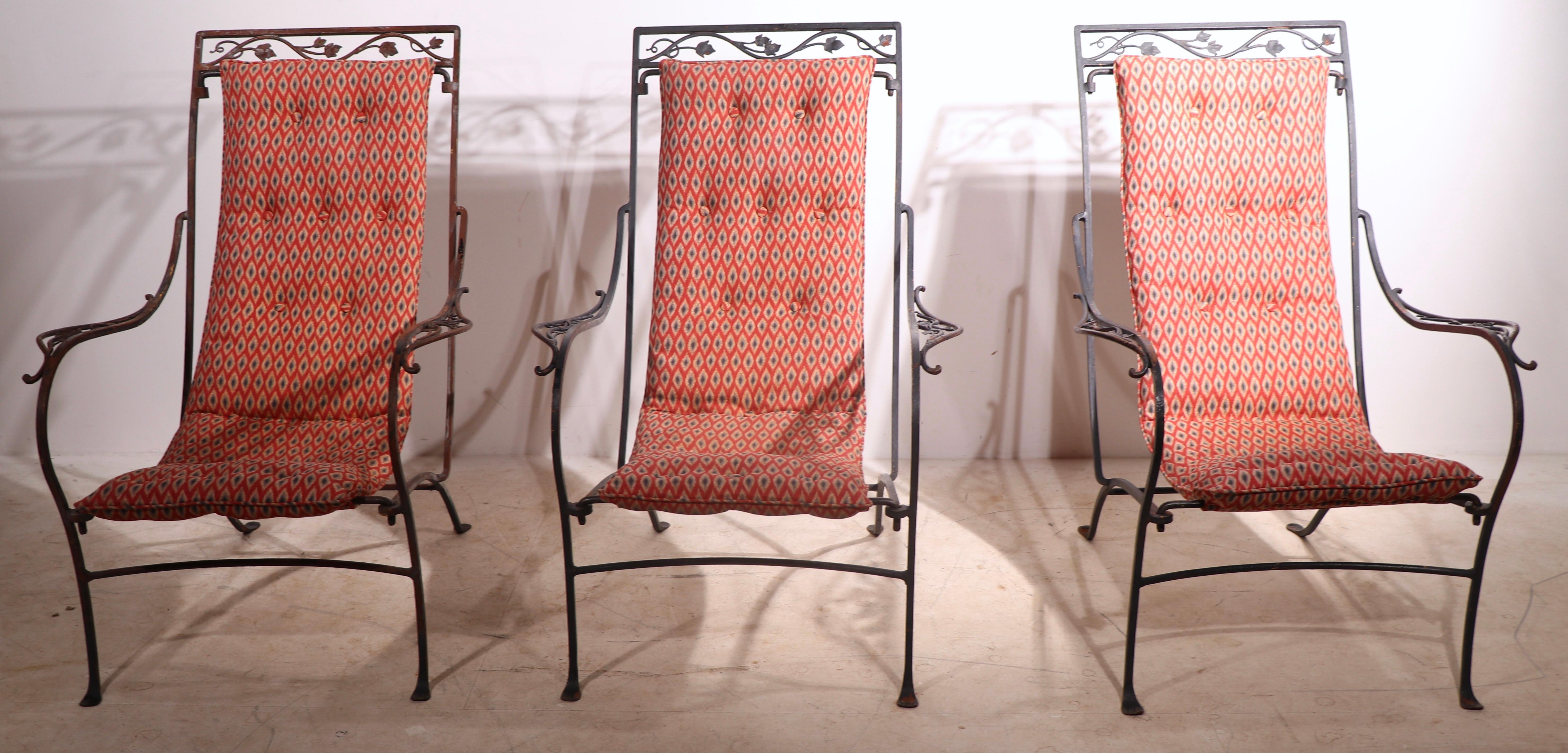 Voguish suite of three sling seat lounge chairs by noted garden furniture maker, Salterini. The chais features a suspended upholstered continuous back, seat rest in original diamond pattern fabric, on exquisite hand wrought frames. All three are in