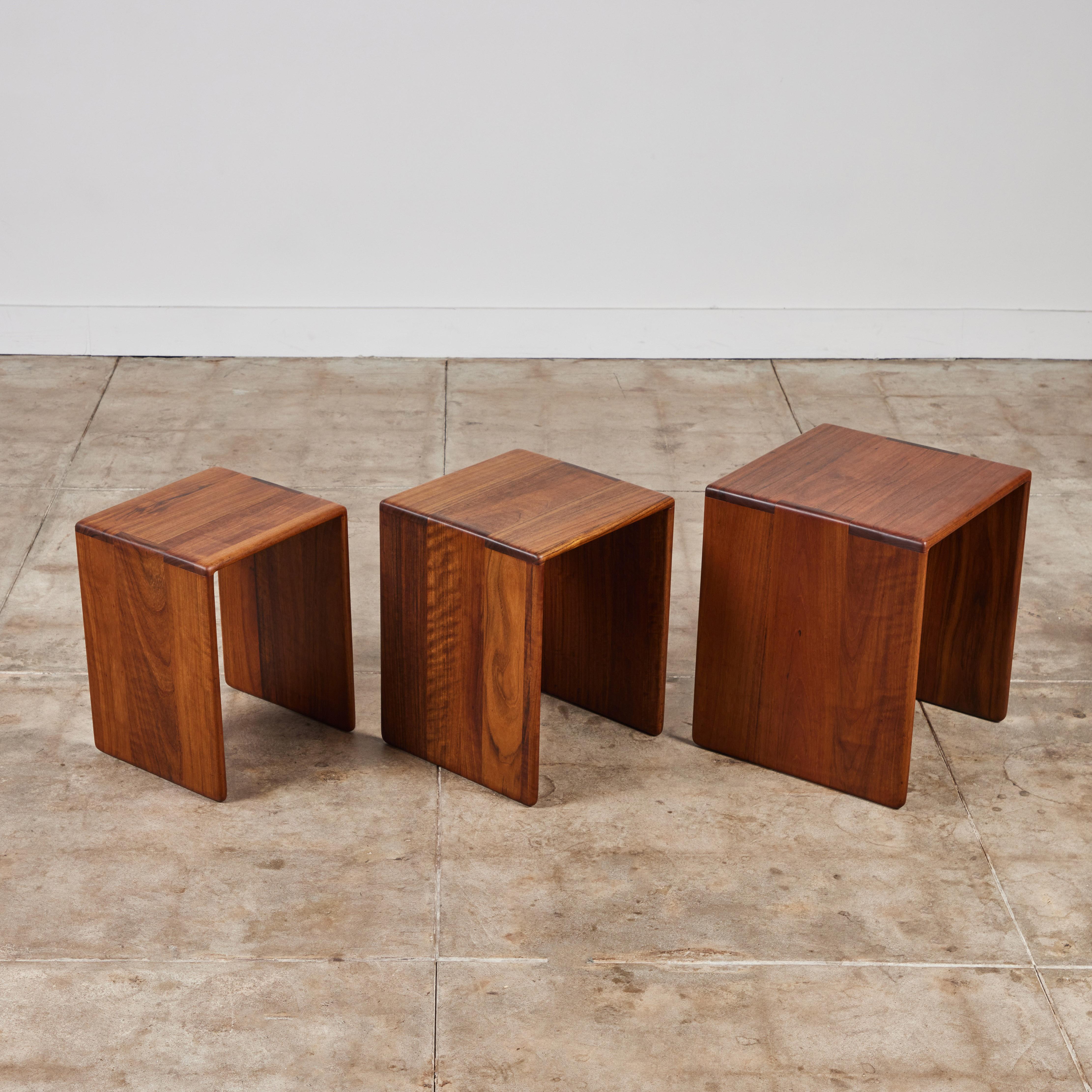 Set of three nesting tables in shedua wood from American designer Gerald McCabe for Eon Furniture, c.1970s. The tables have a waterfall shape with rounded edges finished with finger joinery. Each table displays a beautiful and unique wood grain. The