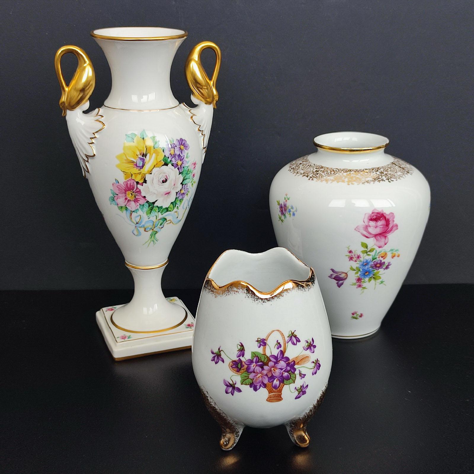 Set of Three German Porcelain Vases, Mid-Century, KPM
Comprising (from left to right):
- a Parbus egg shaped porcelain vase, resting of three gilt feet, height 14 cm, Ø 10 cm
- an Alka Kunst Gold Swans handled vase, height 29 cm, Ø 14 cm
- a KPM