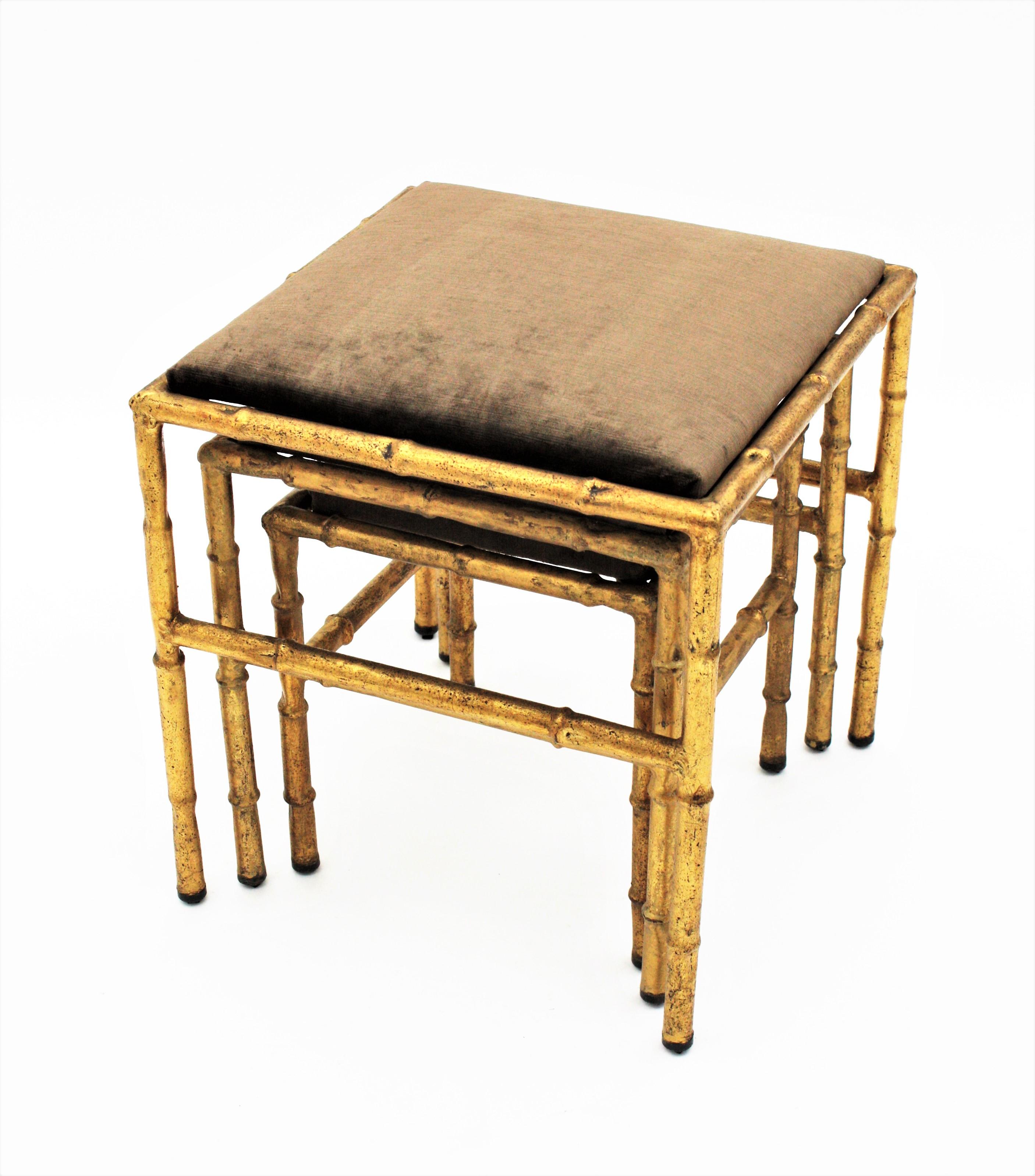 Hollywood Regency Set of Three Gilt Iron Faux Bamboo Nesting Stools Upholstered in Taupe Velvet