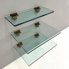 Set of three glass shelves with holder in bronze