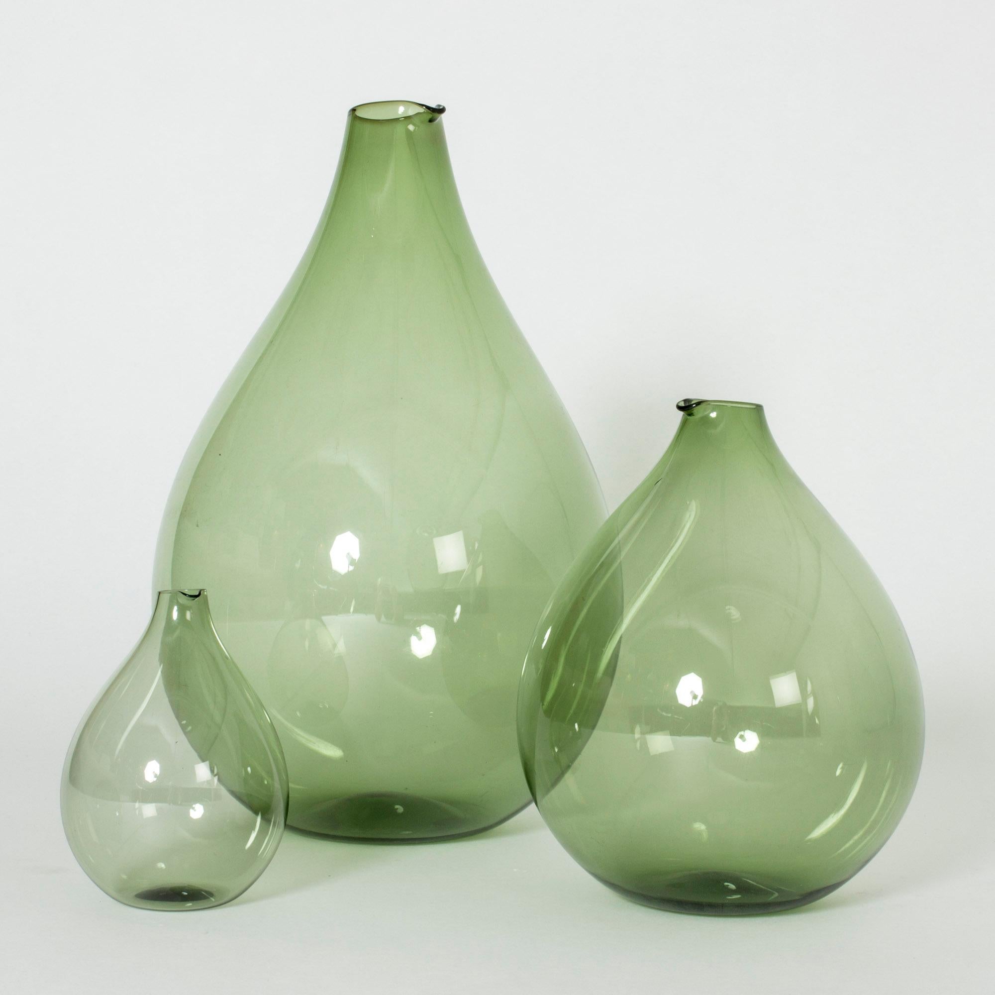 Set of three beautiful vases or decanters by Kjell Blomberg. Made in thin, green glass with a look of soap bubble delicacy, in generous drop shapes.