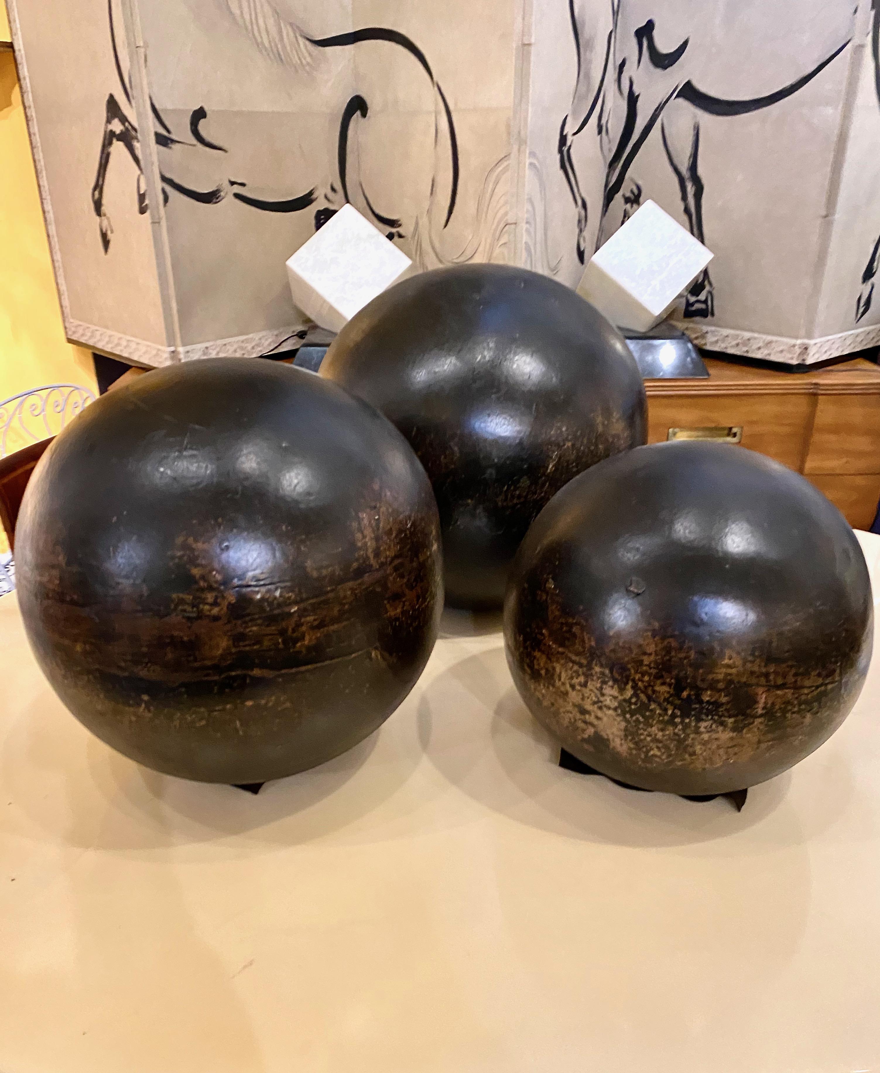 This is a rare set of three graduated black glazed terra cotta garden spheres that date to approximately the third quarter of the 19th century. The spheres are graduated in size with the smallest sphere measuring 13