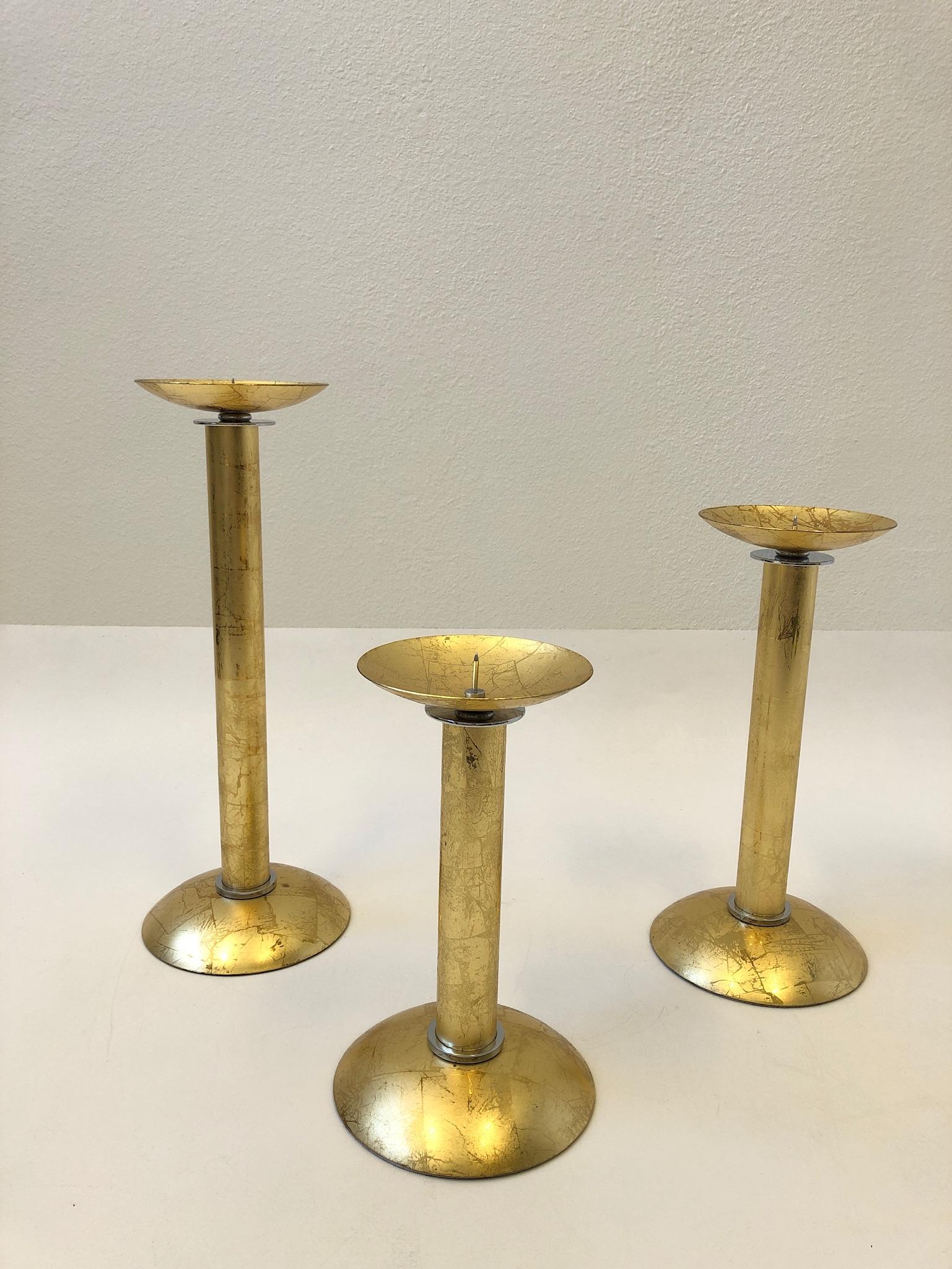 Polished Set of Three Gold Leaf Brass and Chrome Candlesticks by Karl Springer For Sale