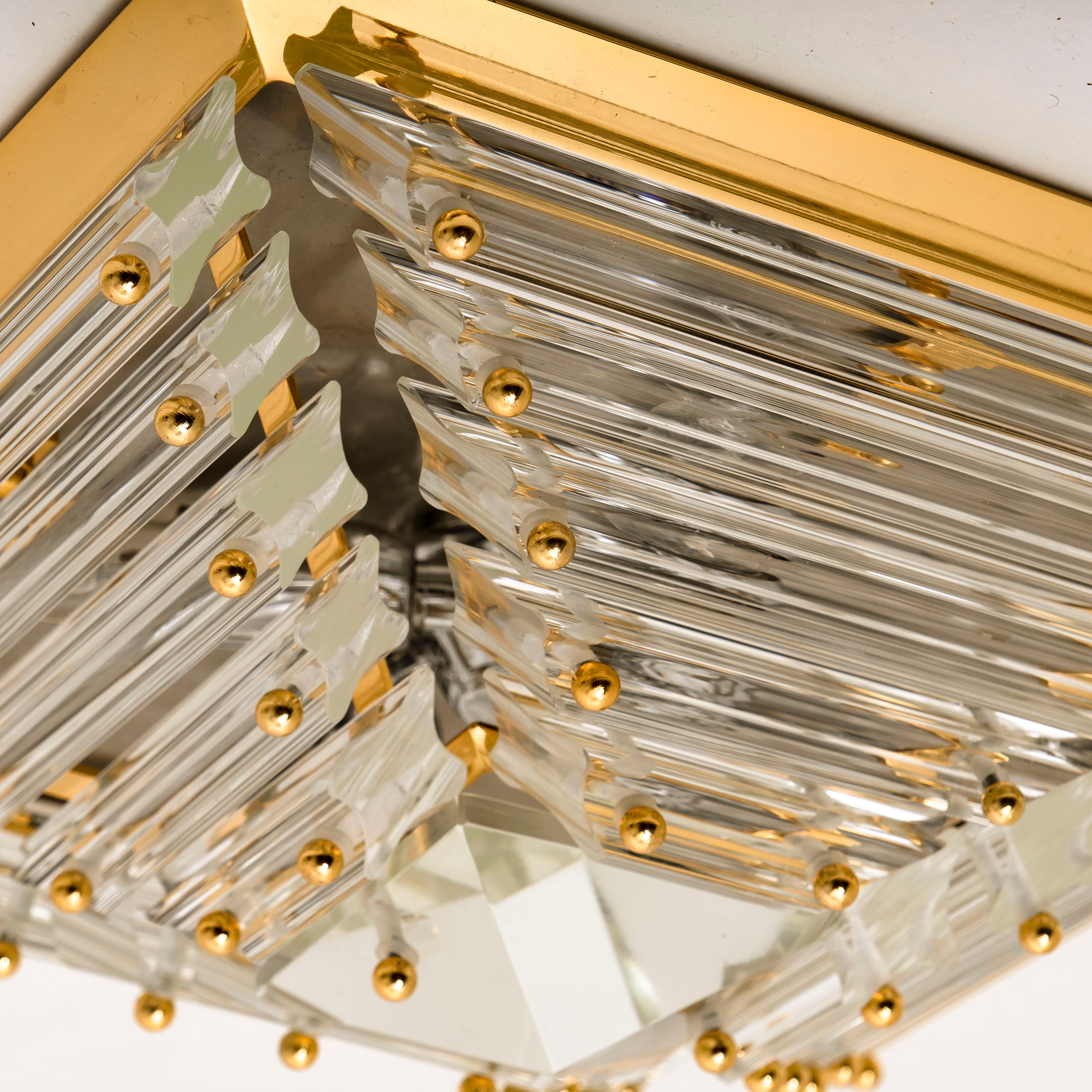 An exceptional set of three gold-plated Venini flush mounts with faceted clear crystal tubes of Murano glass. Modulated in the form of a pyramid. The flush mounts are designed and produced by Venini in Italy from the 1970s. The Murano tubes are
