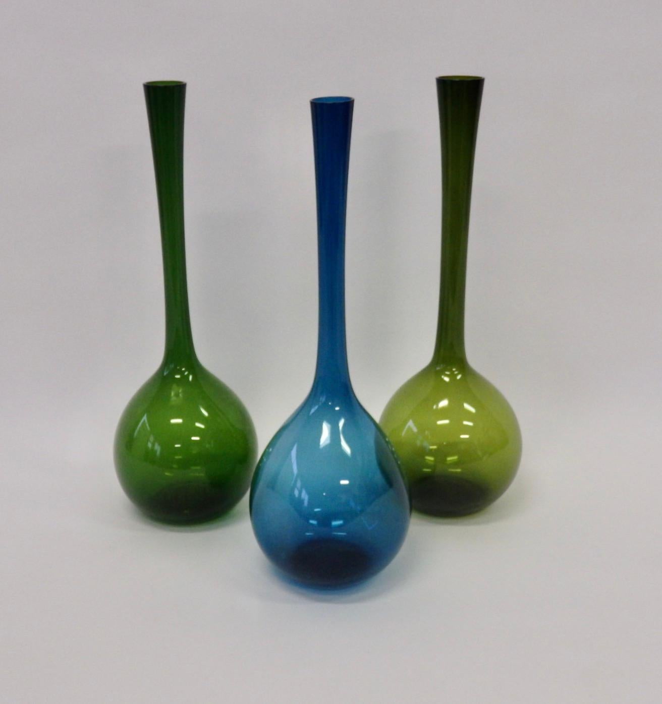 Set of three Arthur Percy bottle vases. Two different shades of green one blue. Blue vase has pinched sides.