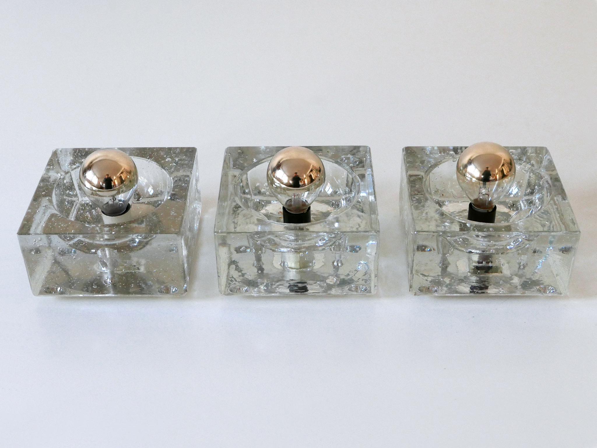 Set of three elegant Mid-Century Modern hand blown ice glass cube wall lamps or sconces in the style of Cubo Sfera by Allessandro Mendini. These ones are designed and manufactured by Müller & Zimmer in 1970s, Stuttgart, Germany.

Executed in thick
