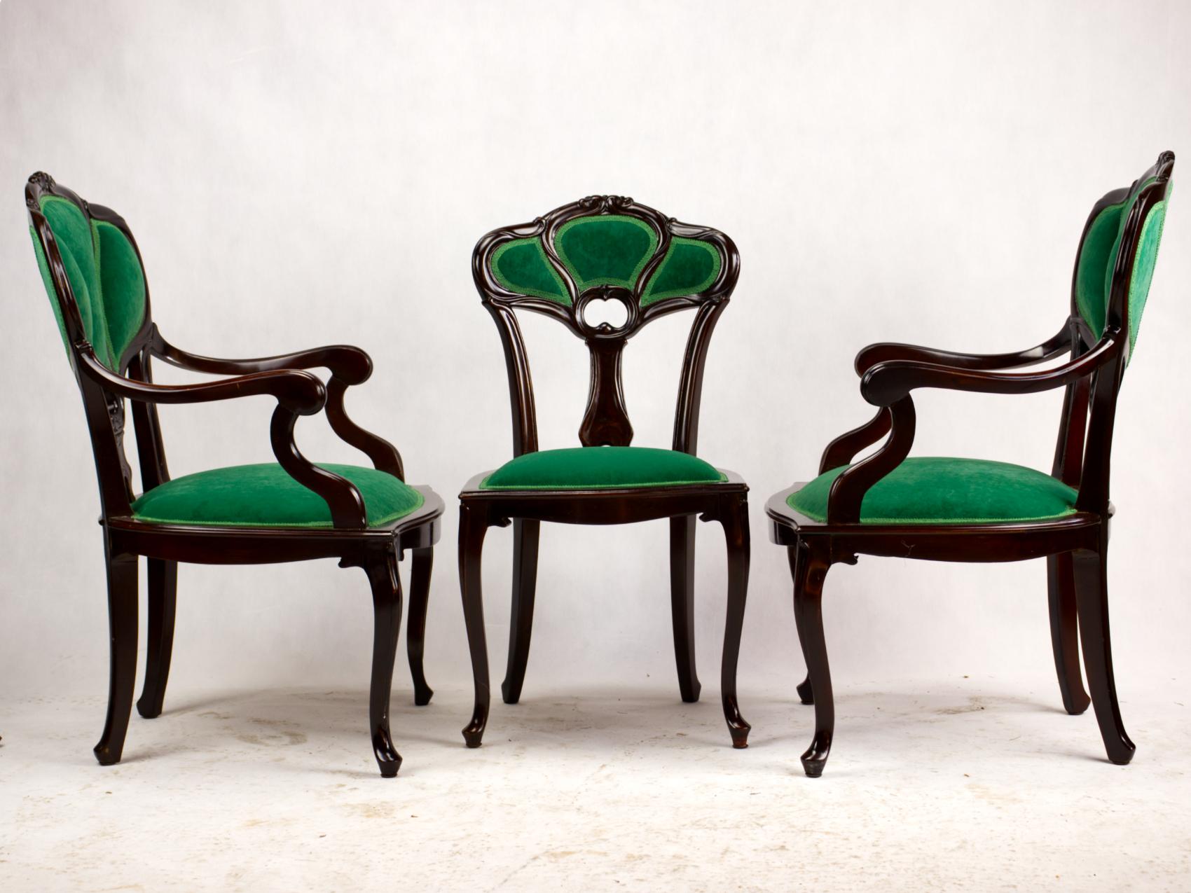 Set of three Art Nouveau early 20th century Art Nouveau armchairs. Beautifully carved chair frame made of fruitwood with upholstered seats and backrests upholstered in the shape of three leaves on cabriole legs. The chairs are completely renovated