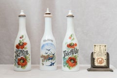 Set of Three Hand-Painted Milk Glass Barber Shop Bottles, circa 1900