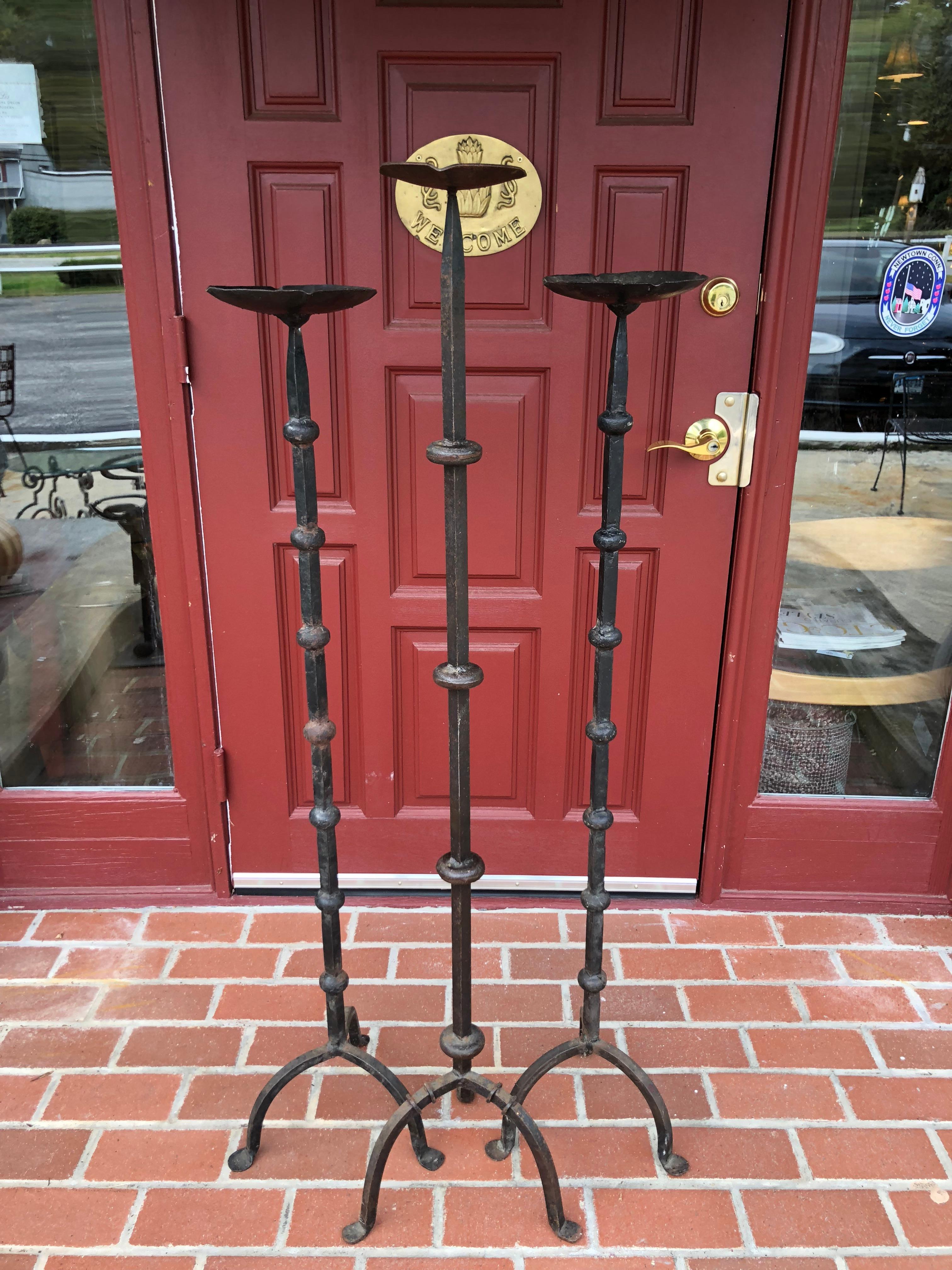  Huge Set of Three Hand-Wrought Iron Altar floor candle stands. Heavy and solid construction. Almost  4 feet in height. These most likely came out of an old church in New England. . They weigh about 35 pounds total and are well constructed , solid ,