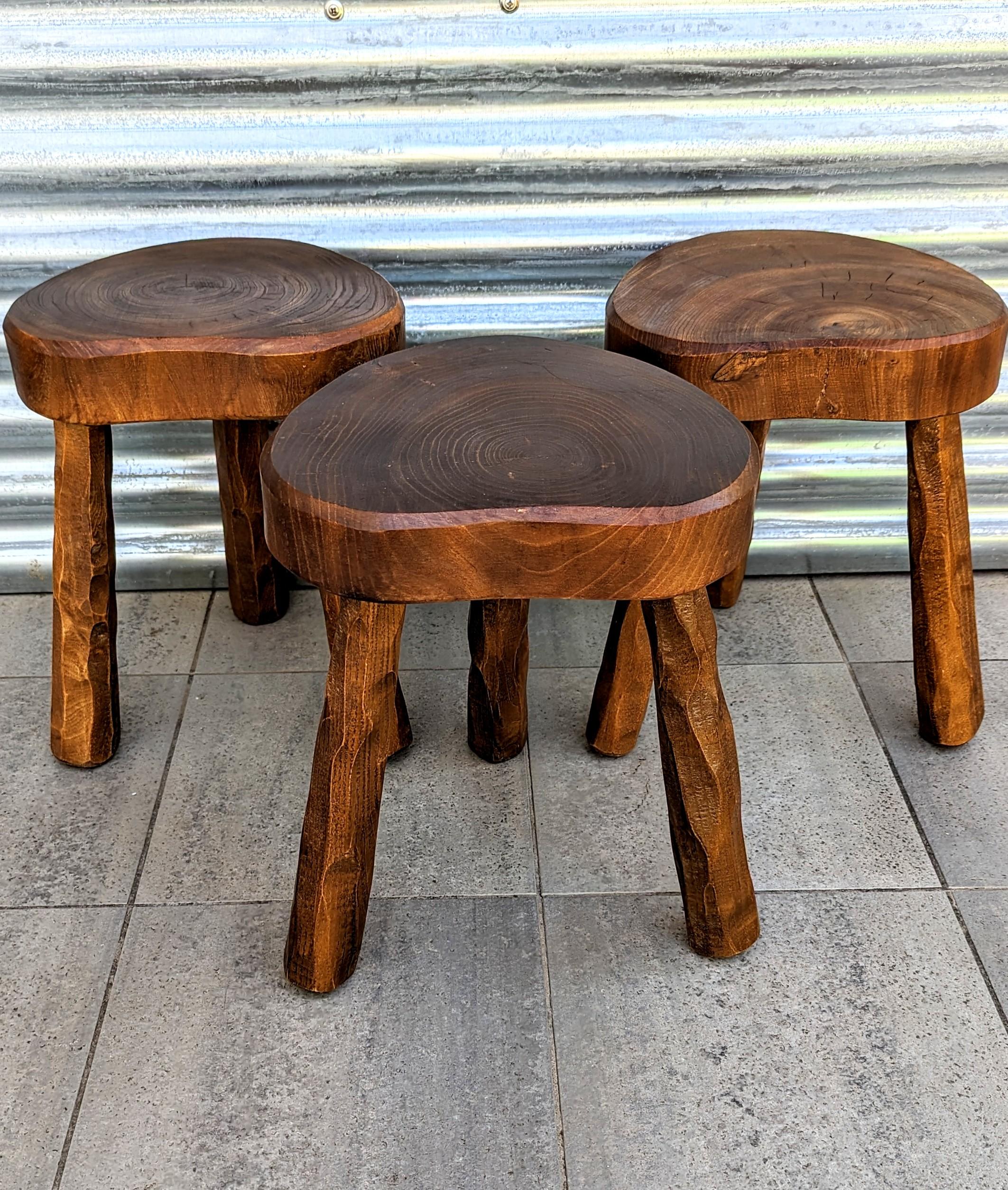Rare ans beautiful set of three handmade wooden stool manufactured in France in 1960s. These magnificent solid wood stools come from a high mountain chalet in the French Alps. Made in the 1960s by a village craftsman.
Their rounded seat shapes