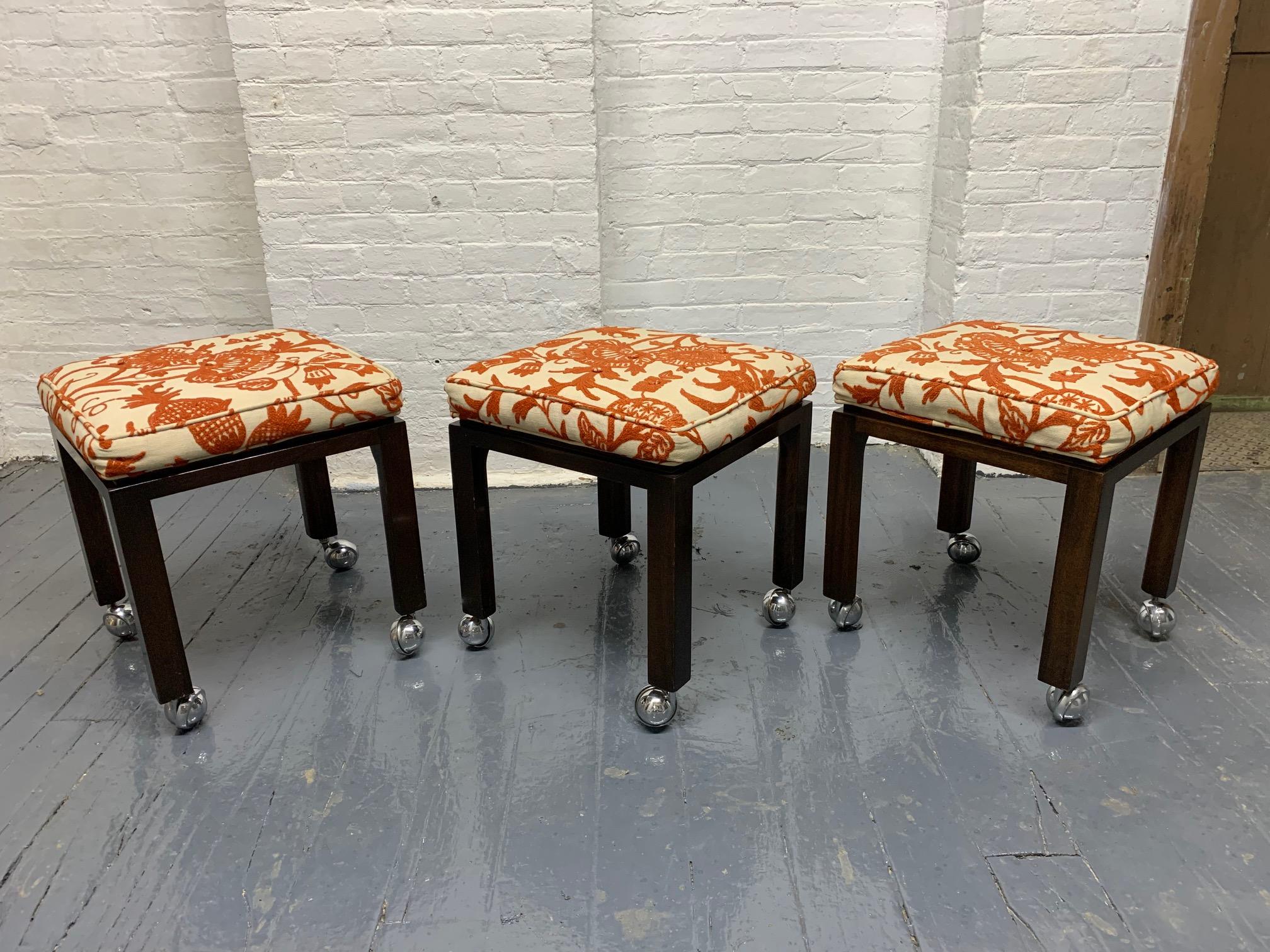 Set of three Harvey Probber stools. Has square walnut legs on casters. Off-white and rust embroidered floral cushioned seats. Mid Century Modern.