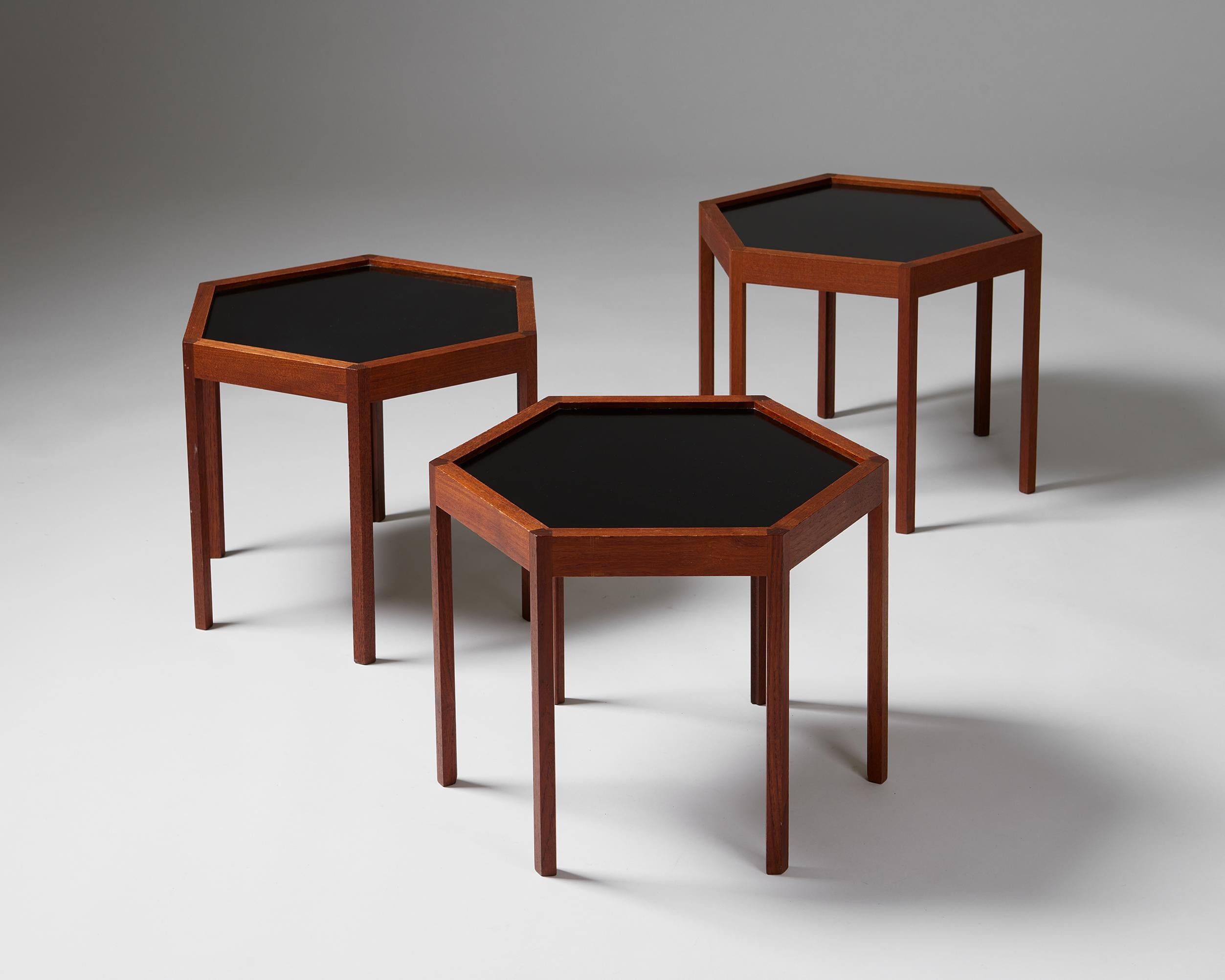 Set of three hexagonal side tables designed by Hans C. Andersen,
Denmark. 1960s.

Teak with formica top.

Measures: 
H: 37 cm / 1' 2 1/2