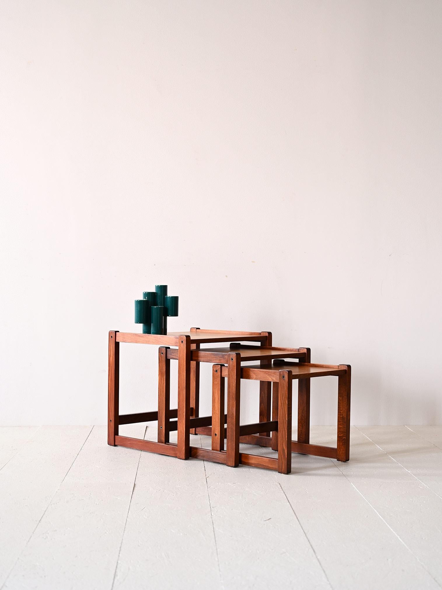 Original vintage 1960s Scandinavian side tables.

This set consisting of 3 coffee tables of different sizes that can be pulled out when needed, is distinguished by the square shape of the table tops and legs.
The essential and clean lines make them