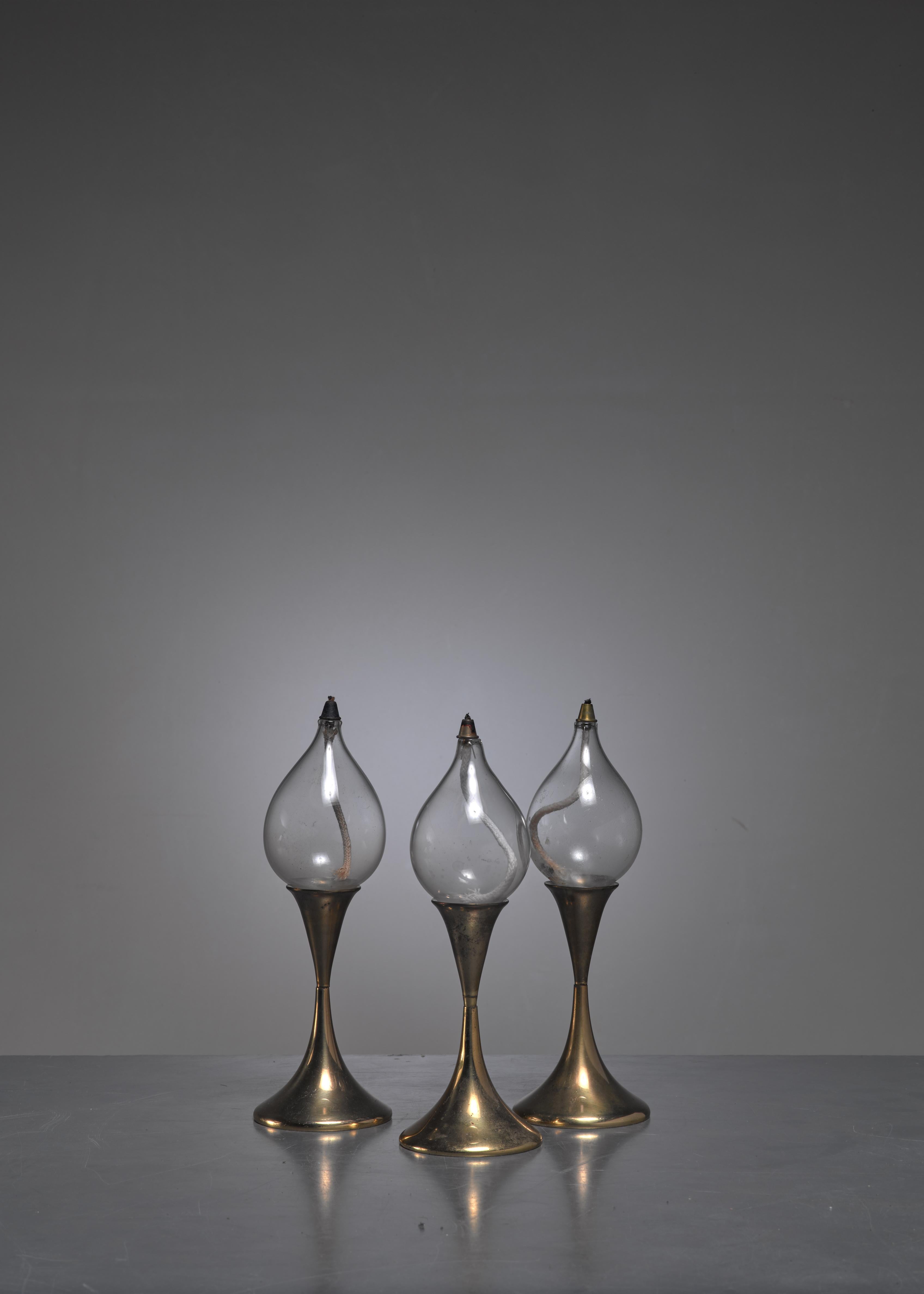 A set of three brass oil lamps or candle holders from Denmark. The pieces are made of brass and have a removable glass oil lamp. Without the glass part they can be used as a candle holder.

The height varies between 25 and 34 cm.

 