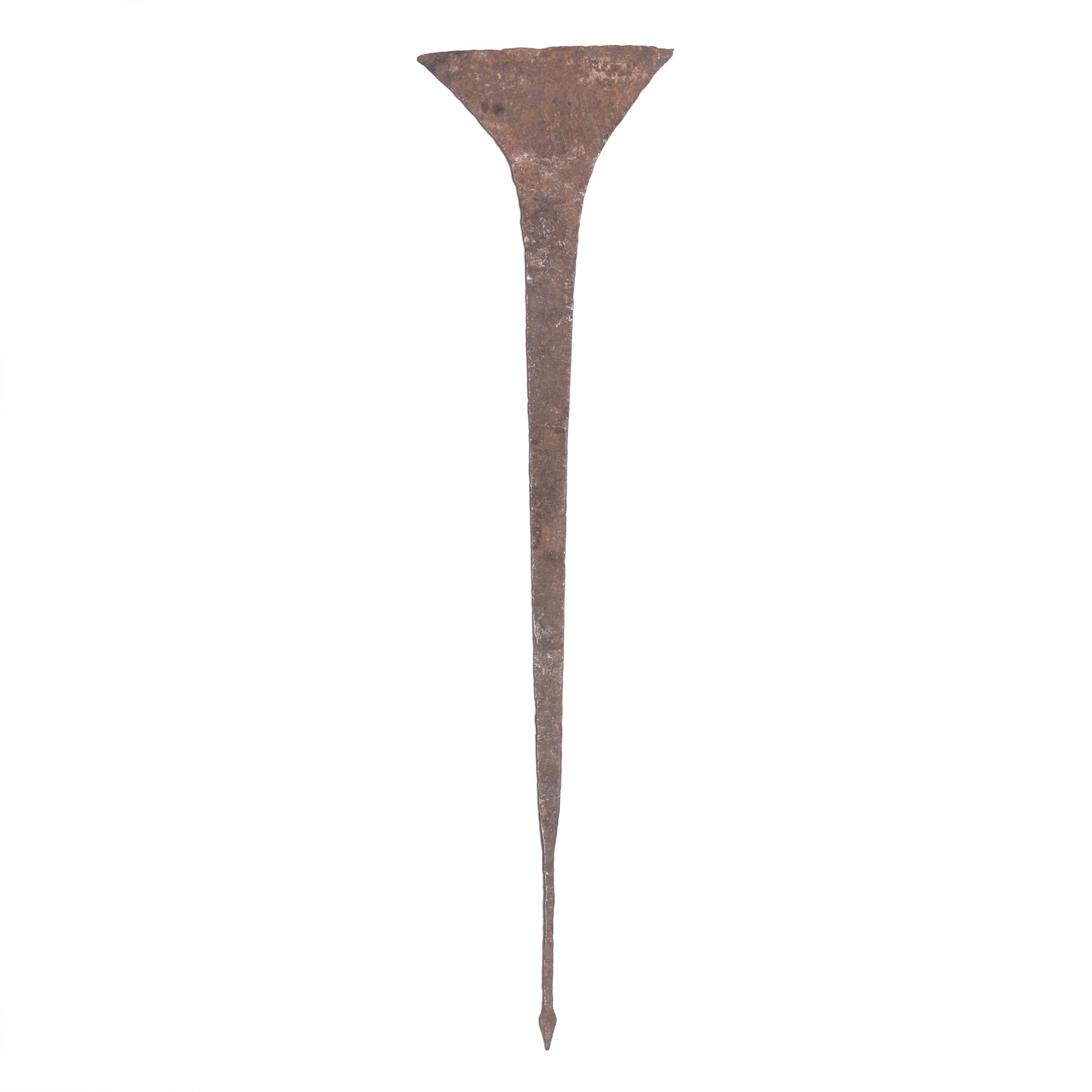 Flaring at the top to suggest a hoe, these elongated sculptural objects were used among the Idoma People of Nigeria as a form of currency. Forged from iron and hammered with horizontal markings to accentuate their tapered shape, the objects are