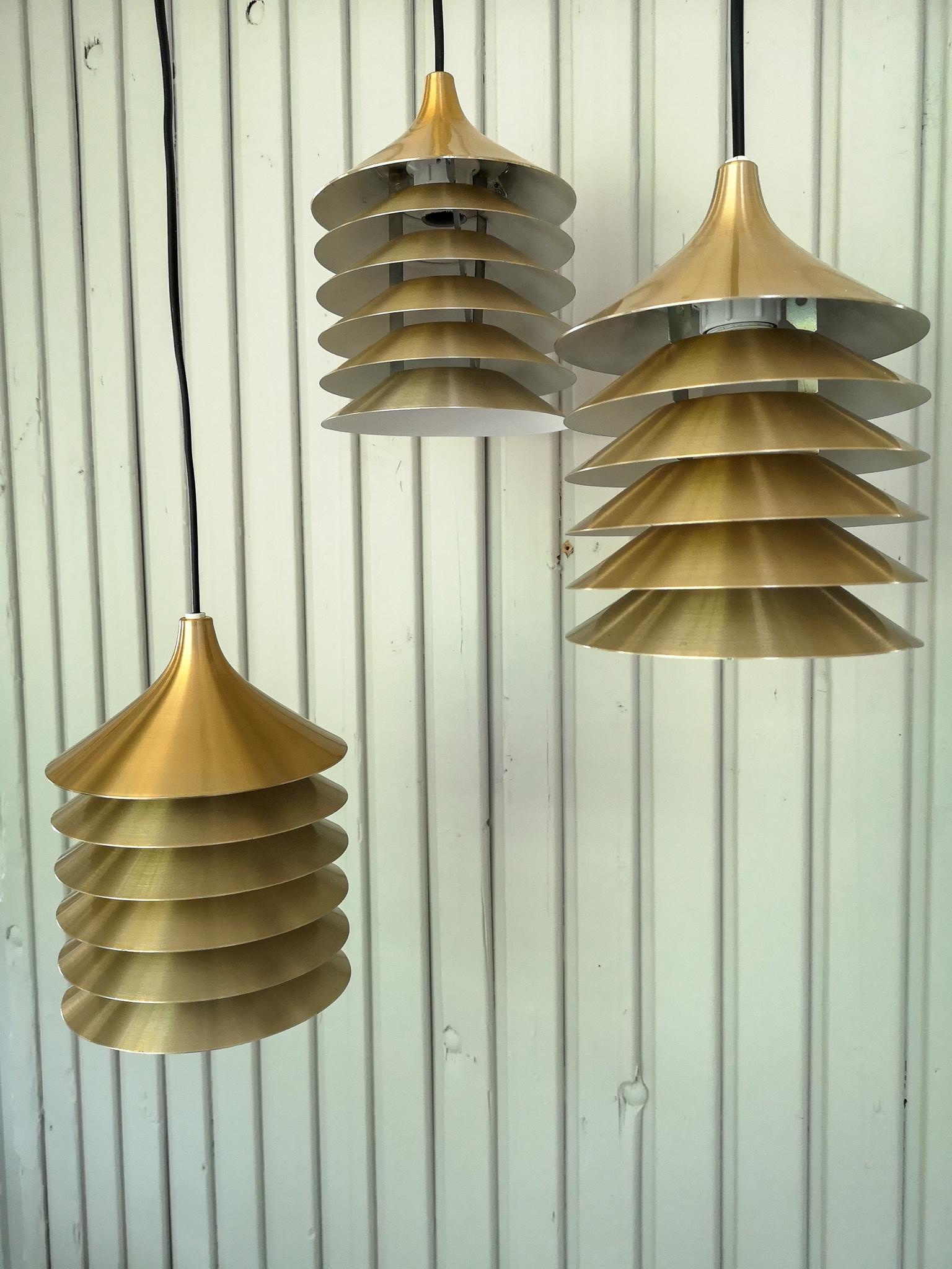 Set of three original, 1970s hanging light designed by Bent Gantzel-Boysen for Ikea, Sweden. This model of the duett collection has 6 metal/brass colored rings.
The light has a E14 socket for bulbs, it’s been rewired. These three brass colored is