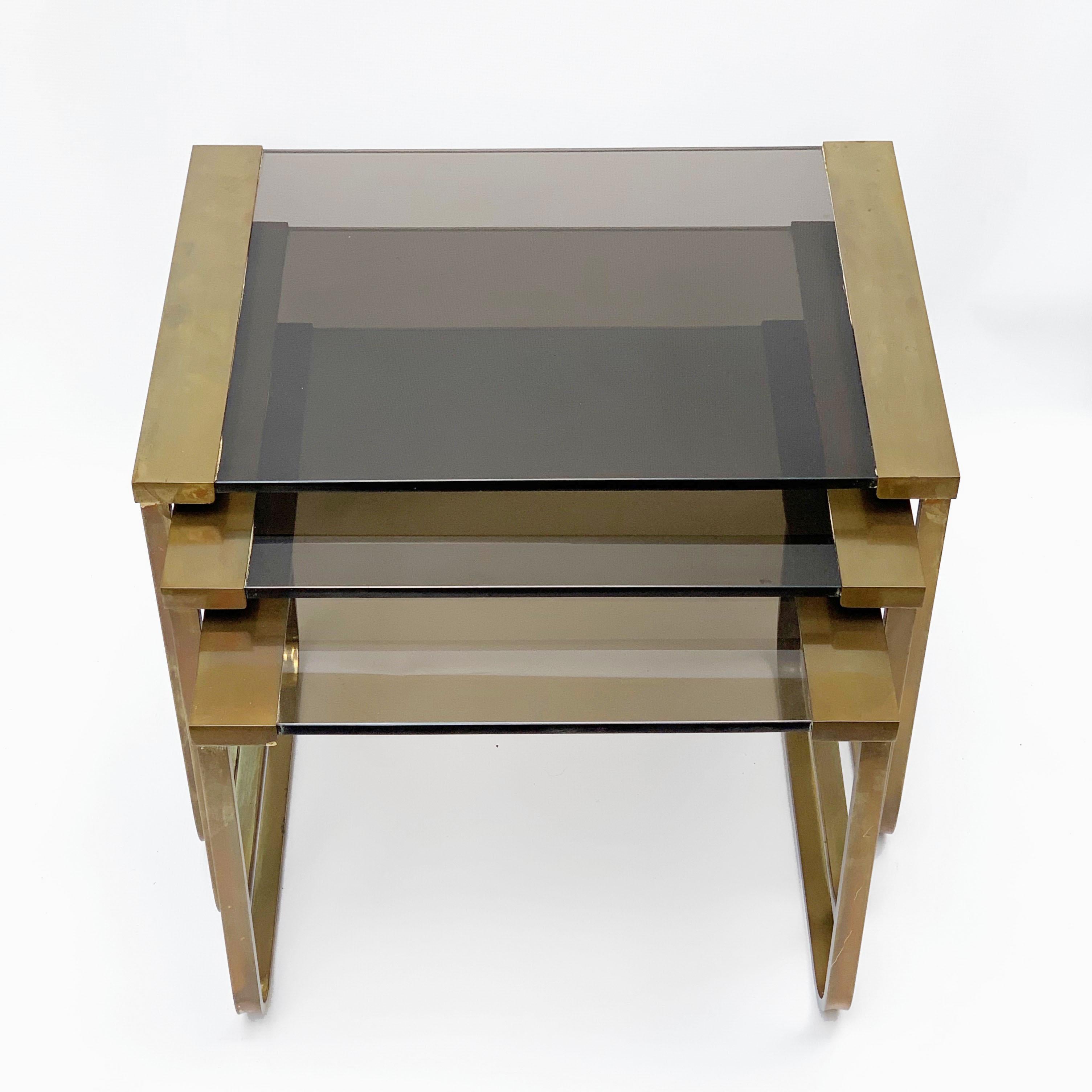 Beautiful set of three interlocking tables in satin brass and smoked glass.
Solid burnished brass. Thick glass with no chipping
Suitable for any type of furniture.

The measurements of the three tables are:
Large 15.94x 21.85x16.14
Medium