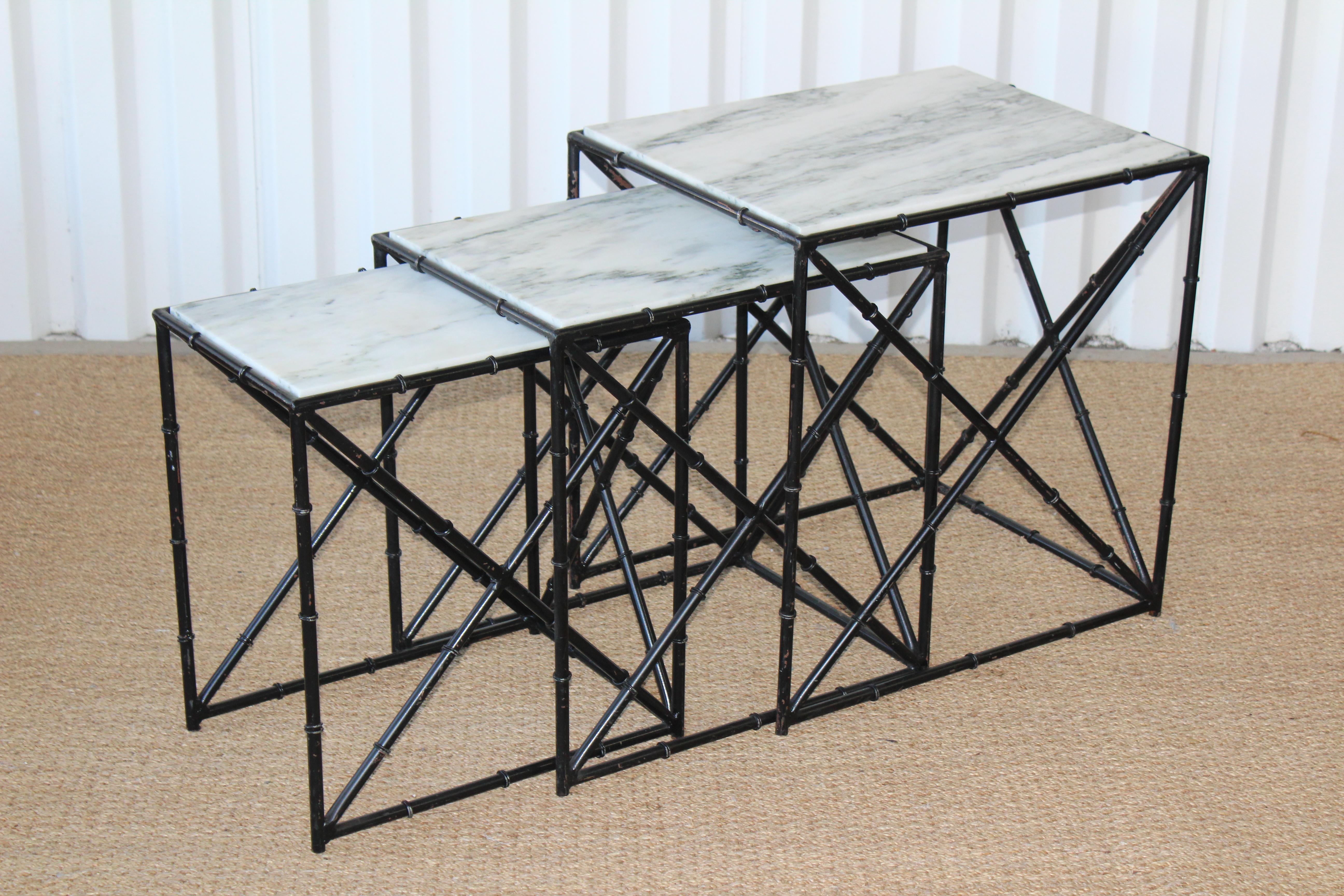 Set of three iron bamboo motif nesting tables with marble tops. New Italian marble tops. The iron frames have been left as-is and show age appropriate patina. 
Measures: Large table: 20