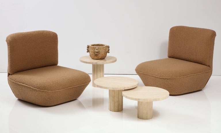 A set of three Italian 1970's travertine coffee tables featuring an elegant and balanced design. The circular tables have no joints or clamps and are architectural in their structure. Each tabletop rests on a single cylindrical fluted columnar base,