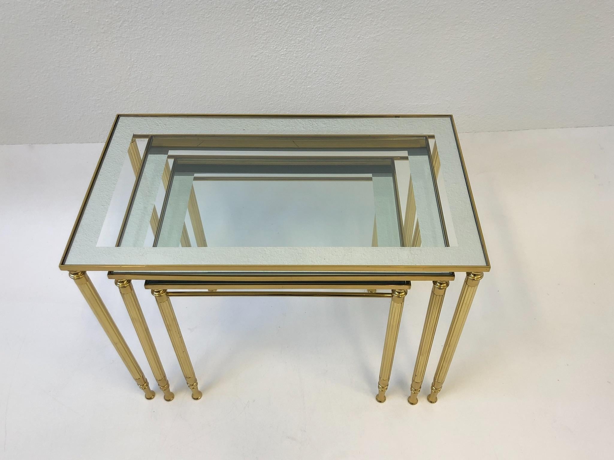 Polished Set of Three Italian Brass and Glass Nesting Tables by Maison Baguès