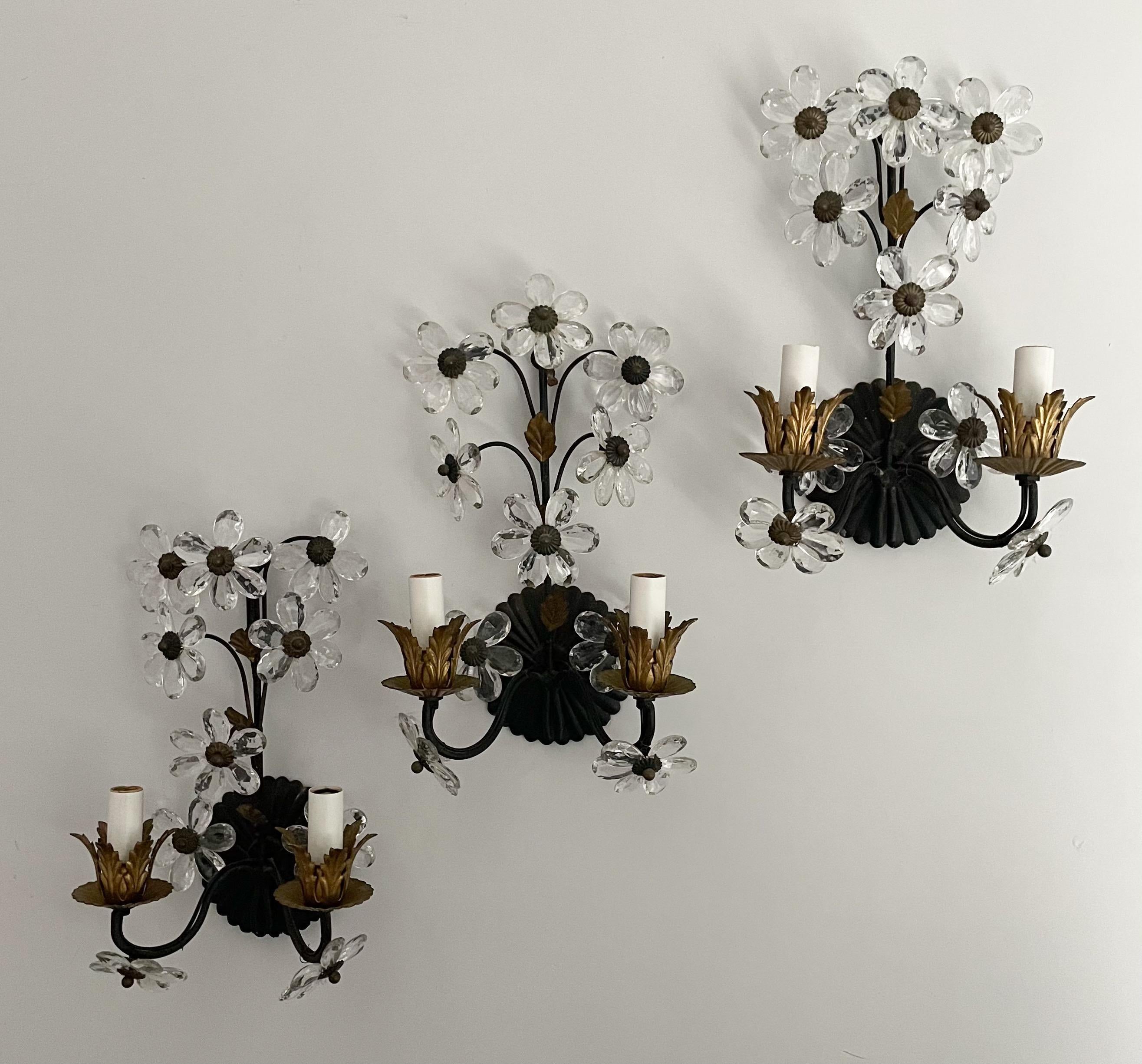 Beautiful set of 3 Italian painted and parcel-gilt iron sconces with crystal flowers. 

Each sconce consists of an iron frame with a black finish and gilt-metal foliage. Flowers made of faceted crystal prisms give each sconce the semblance of a