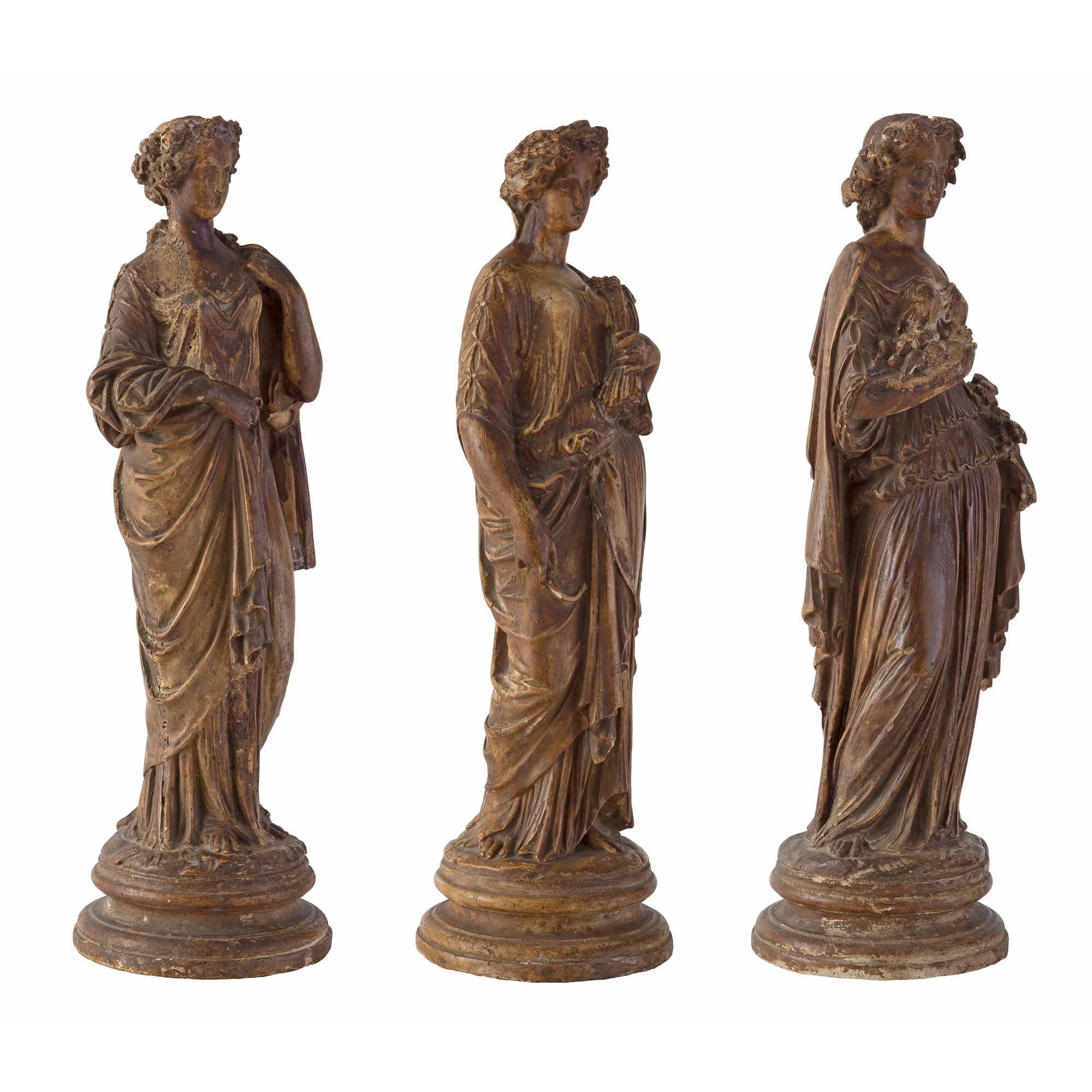 A beautiful and complete set of three Italian early 18th century neo-classical period terra cotta statues of maidens signed C PIERI. Each wonderfully executed statue is raised by a circular mottled base. Detailed maidens are draped in flowing