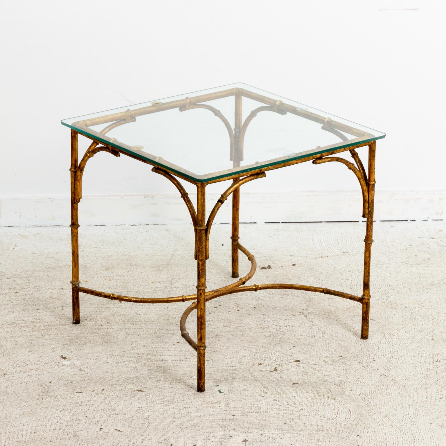 Circa 1960s set of three Hollywood Regency style low tables composed of a gilt metal frame with glass tabletops that can be used together as a coffee table or separately. Made in Italy. Please note of wear consistent with age including some old