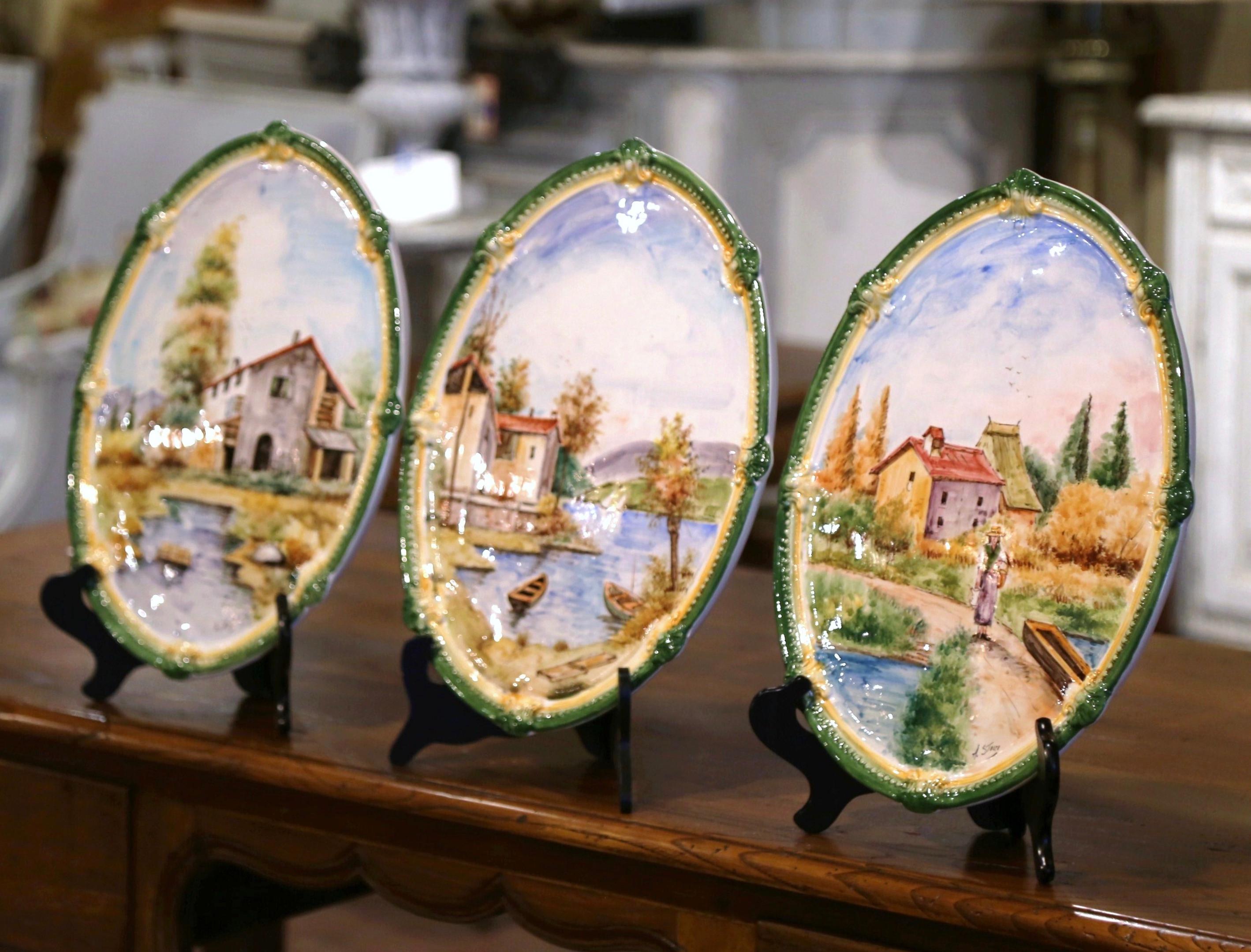 Decorate a kitchen wall or breakfast room with this elegant set of wall platters. Crafted in Italy circa 1980, each plaque depicts a typical Italian country scene with landscape, farm house, lake, boat, trees and peasant people. Every plate features