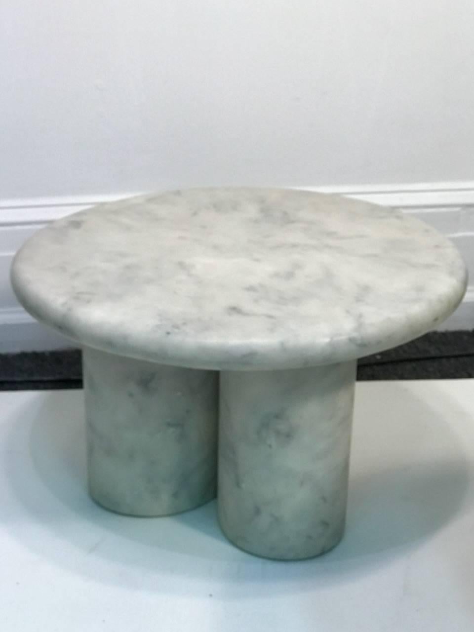 Set of three marble resin tables each with three rounded column legs. Each one is a variance in height. Designed in Italy in the 1970s each one has a measure: 20