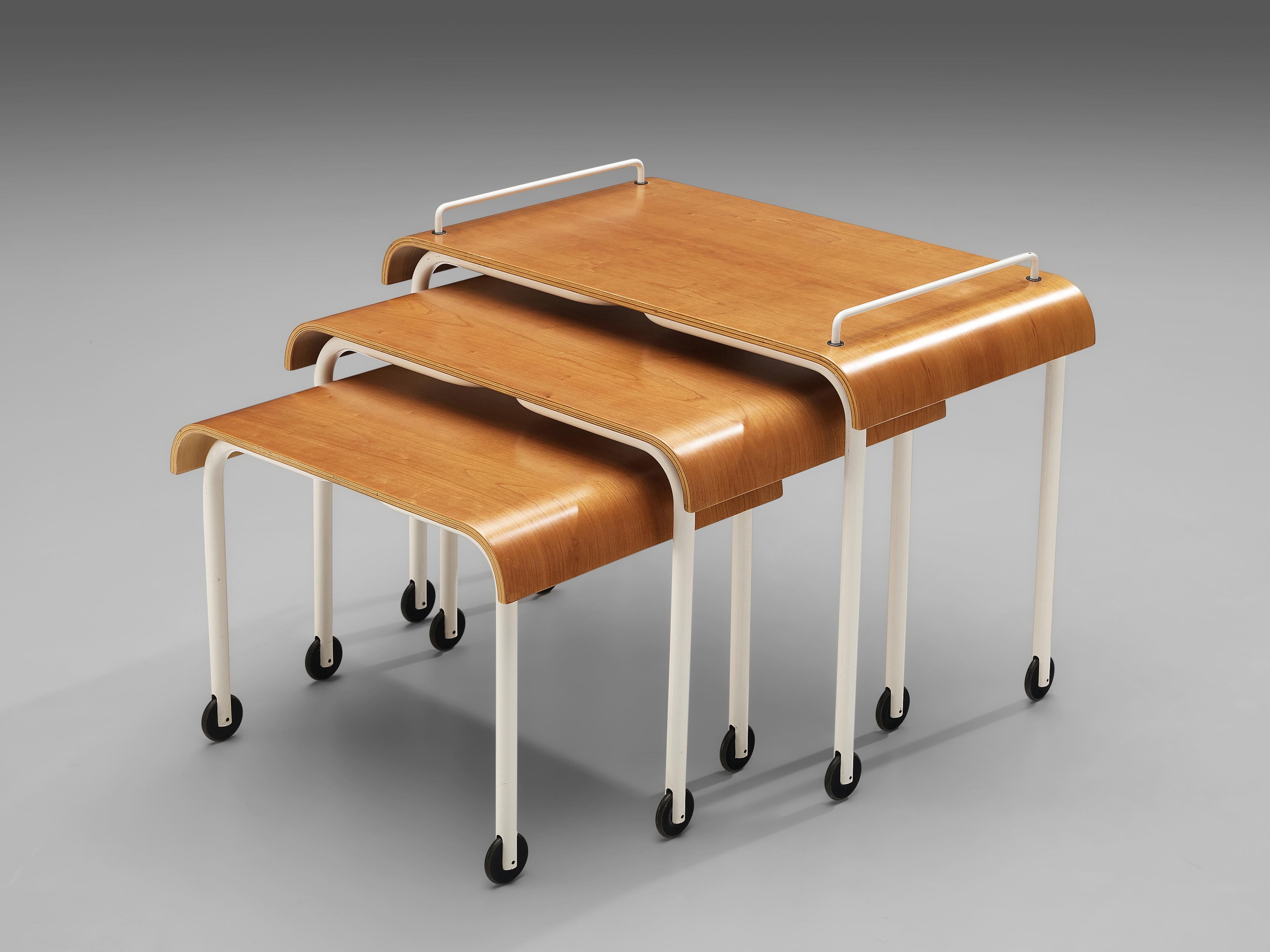 Three nesting tables, plywood, metal, Italy, 1970s

This set of three nesting tables on wheels features white lacquered metal legs and plywood tabletops. On three different heights and sizes the tables can either function as three separate side