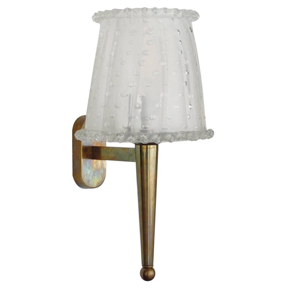 Vintage Italian sconces with lightly frosted clear Murano glass hand blown to produce a lamp shade with bubbles within the glass in Pulegoso technique mounted on a brass bracket / Made in Italy in the 1960’s.