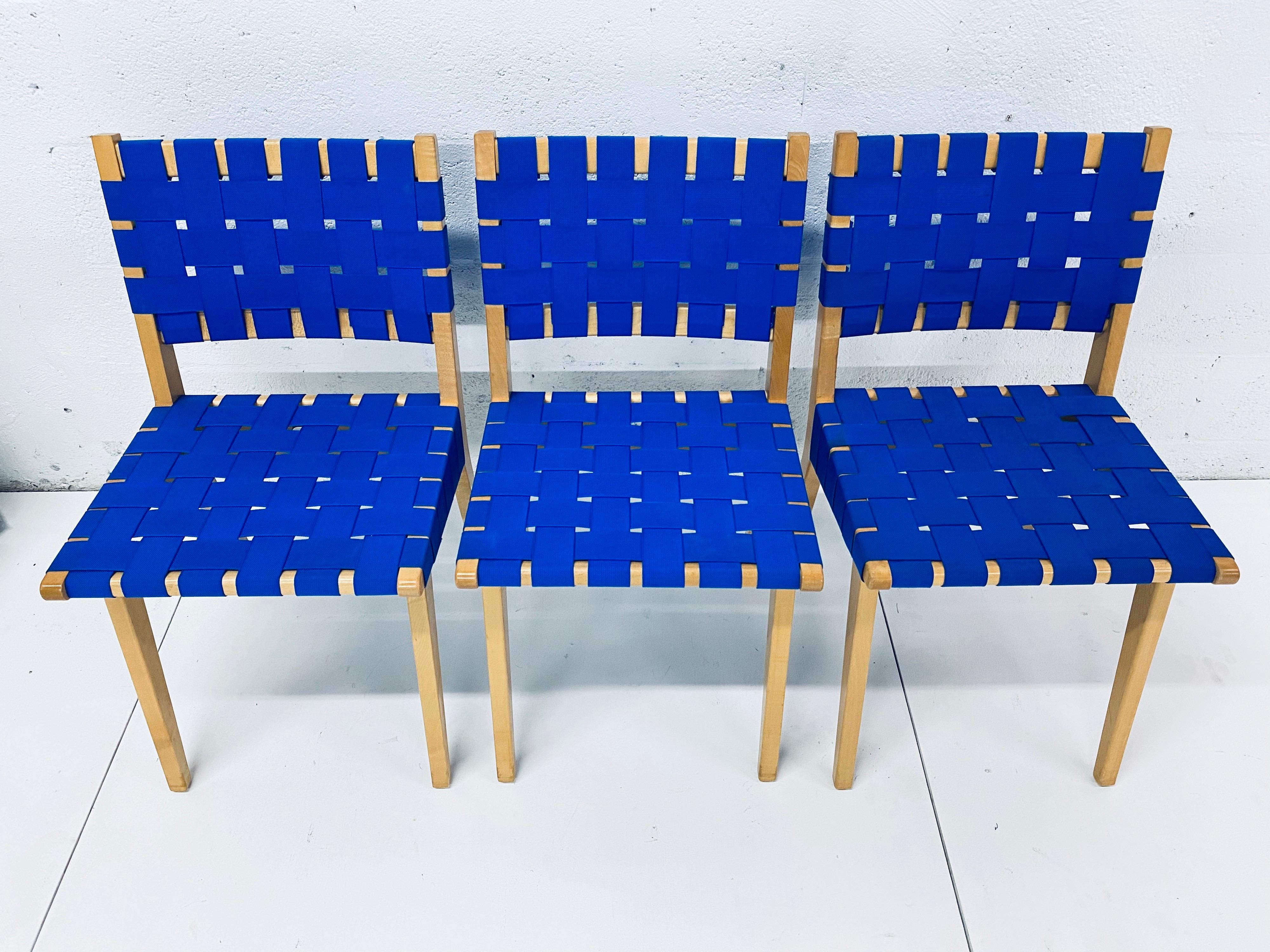 Set of three blueberry nylon webbed chairs with maple frames designed by Jens Risom for Knoll.