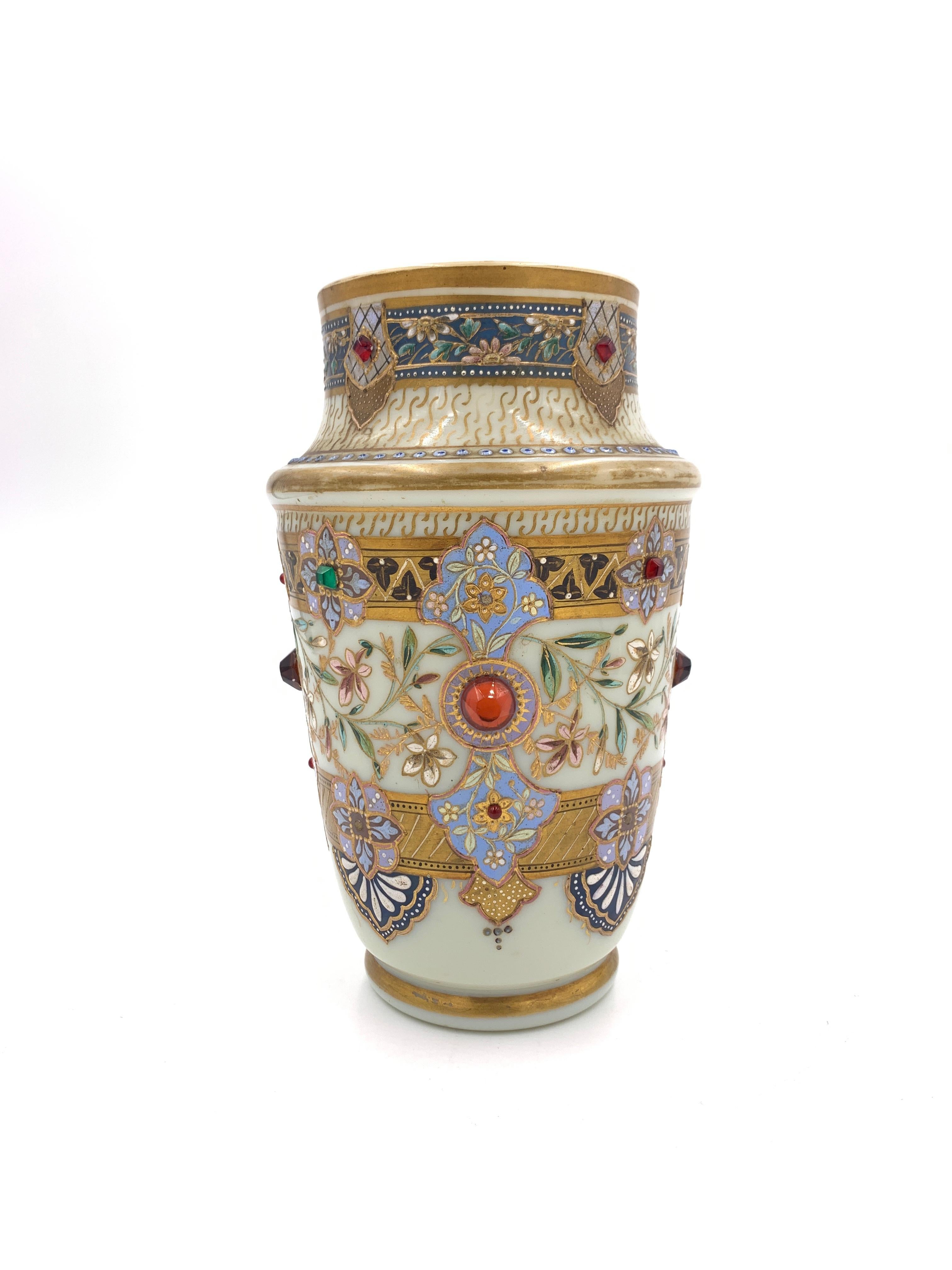 Fine gilded, enamelled and jewelled opaline consists of large centre vase and two identical side vases/bottles. 

 It is missing some jewels, no chips or cracks, some minor gold paint loss, overall in a good condition. 

 Centre vase: Height: