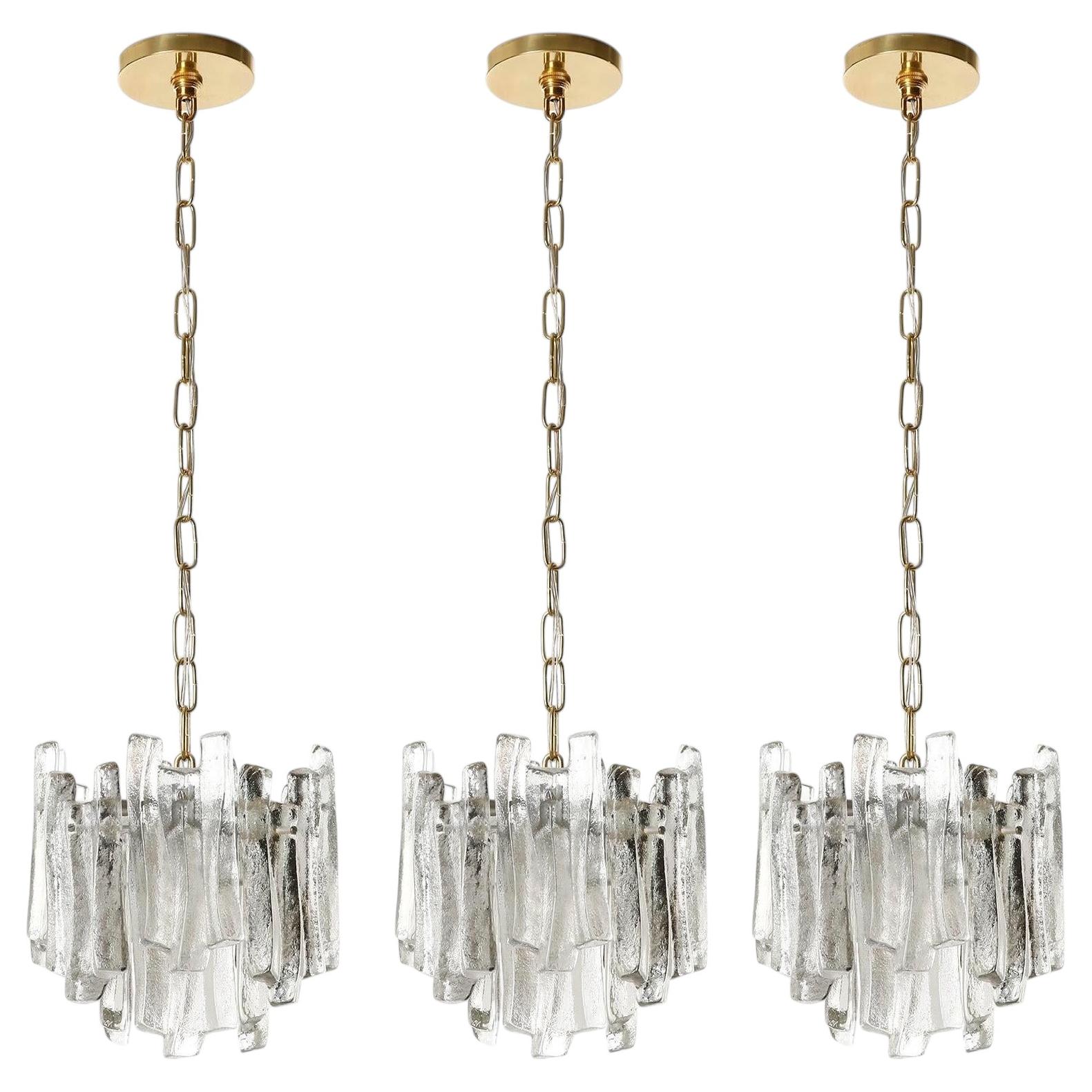 Set of Three Kalmar Ice Glass Chandeliers Pendant Lights, Cast Glass Brass, 1970