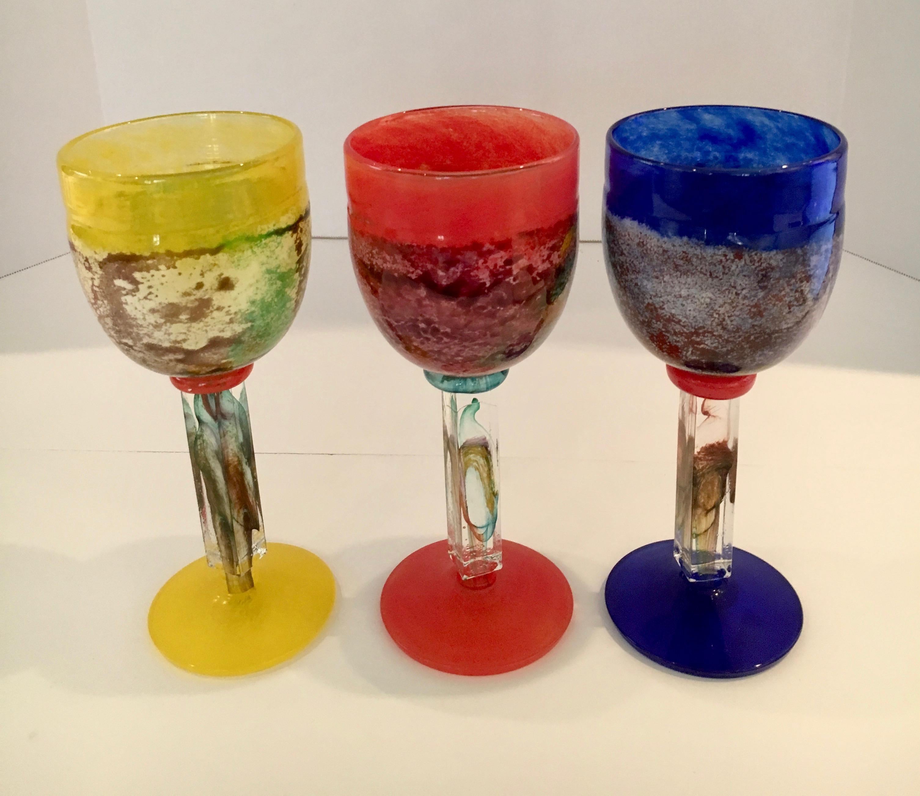 Set of three Kosta Boda stemmed art glasses.