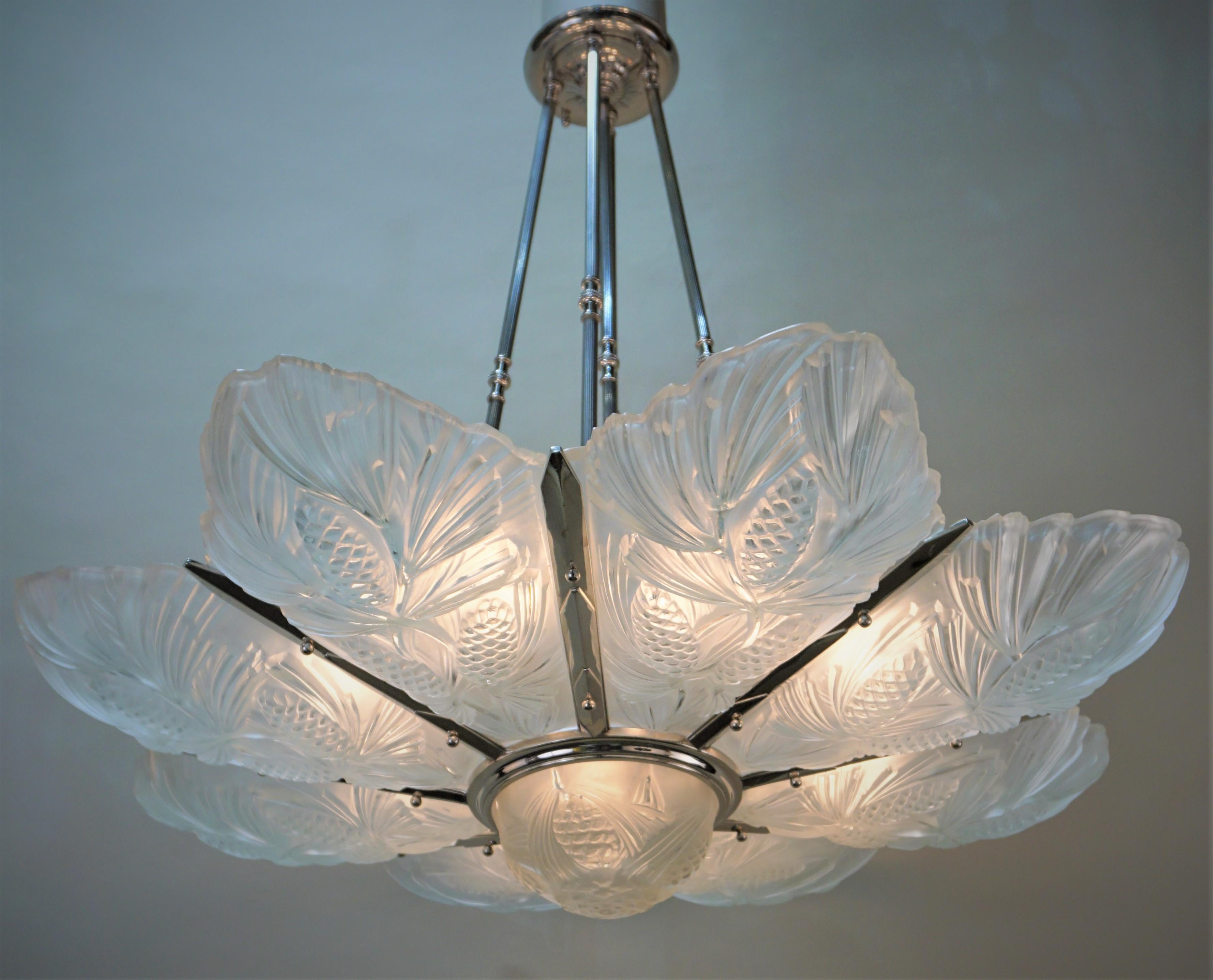 Clear frost glass chandelier with nickel on bronze frame by Marius Ernest Sabino.