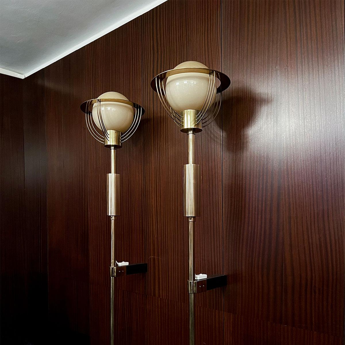 Pair of large sculptural brass wall torchieres with milk glass shades, manufactured in former Czechoslovakia, 1930s.

These large sculptural brass wall torchieres were manufactured in former Czechoslovakia in the 1930s and each consists of a