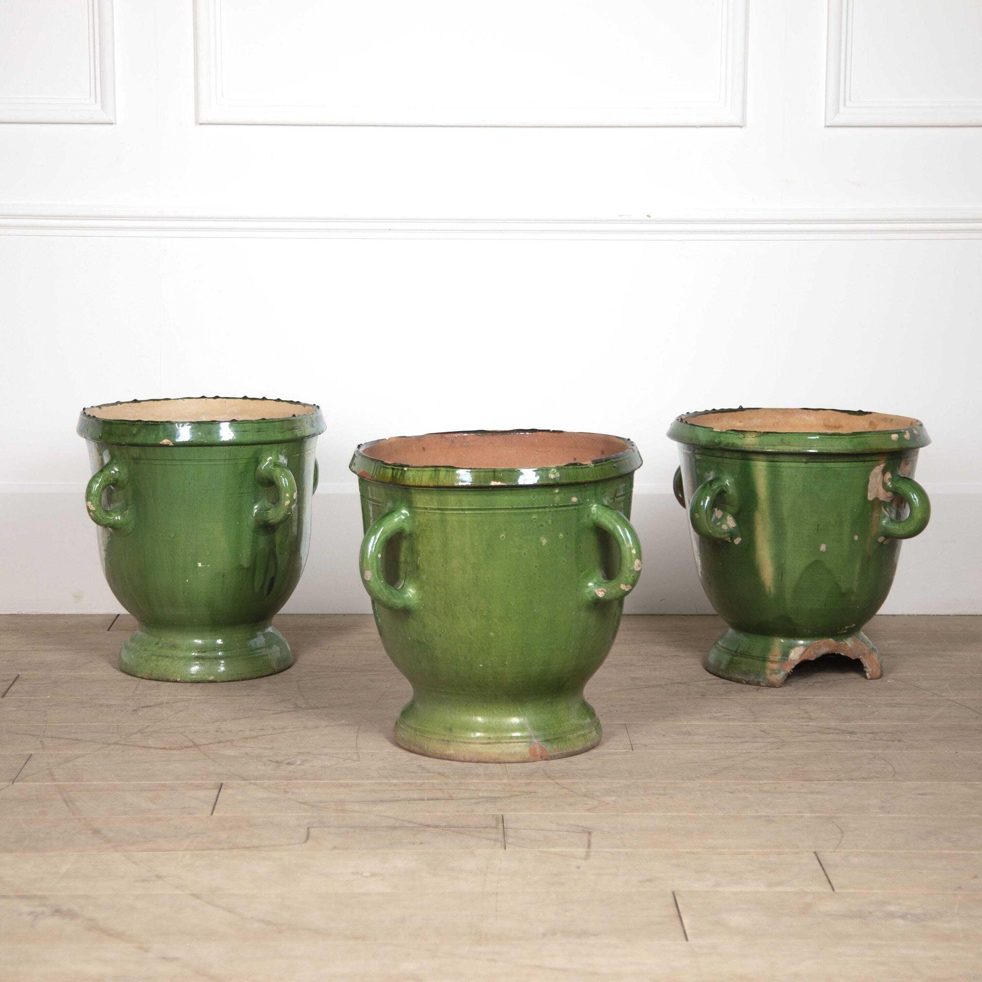 Collection of three large green-glazed Castelnaudary four handled planters.
These pots have come from a private garden in Apt and would have originally graced each side of an entrance to a beautiful home. 
All three date to the 18th to 19th