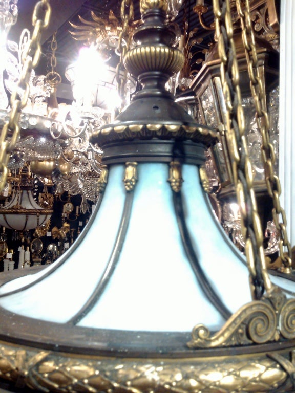 Set of three impressive neoclassical caldwell chandeliers with interior lights. Priced per piece.